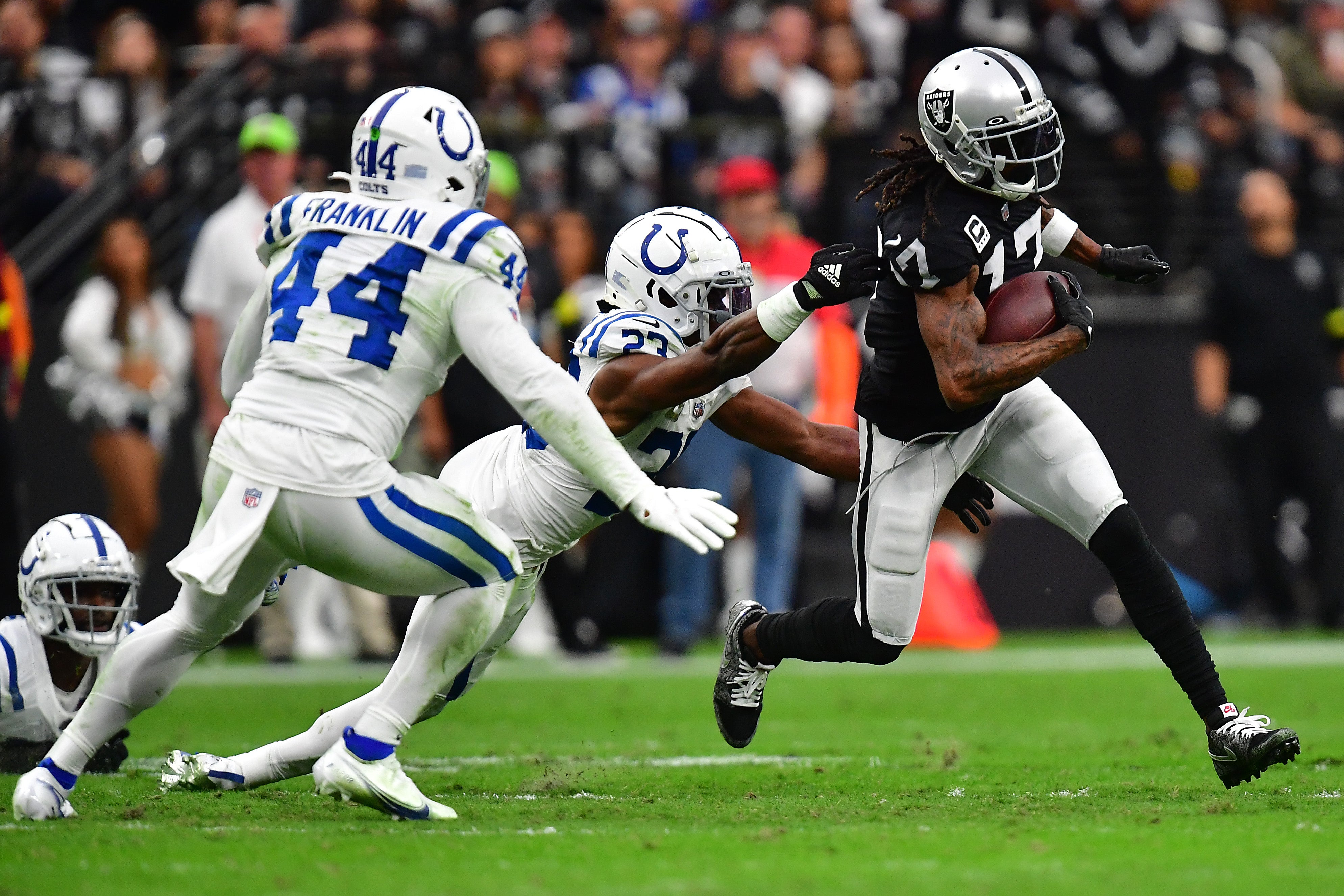 Nov 13, 2022; Paradise, Nevada, USA; Las Vegas Raiders wide receiver Davante Adams (17) runs the ball against Indianapolis Colts cornerback Kenny Moore II (23) and linebacker Zaire Franklin (44) during the first half at Allegiant Stadium.
