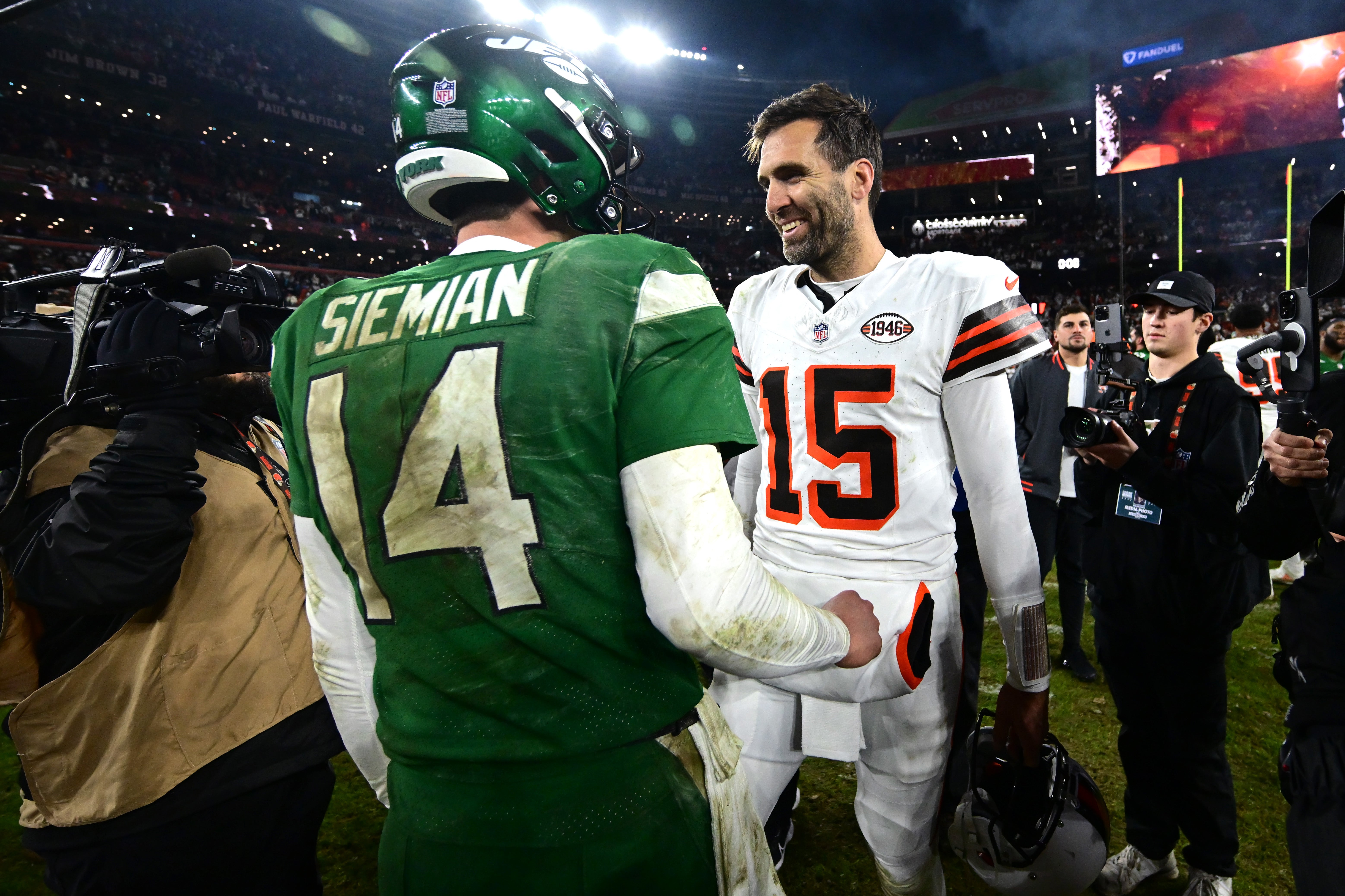 New York Jets quarterback Trevor Siemian (14) and Cleveland Browns quarterback Joe Flacco (15) shake hands after the game at Cleveland Browns Stadium.