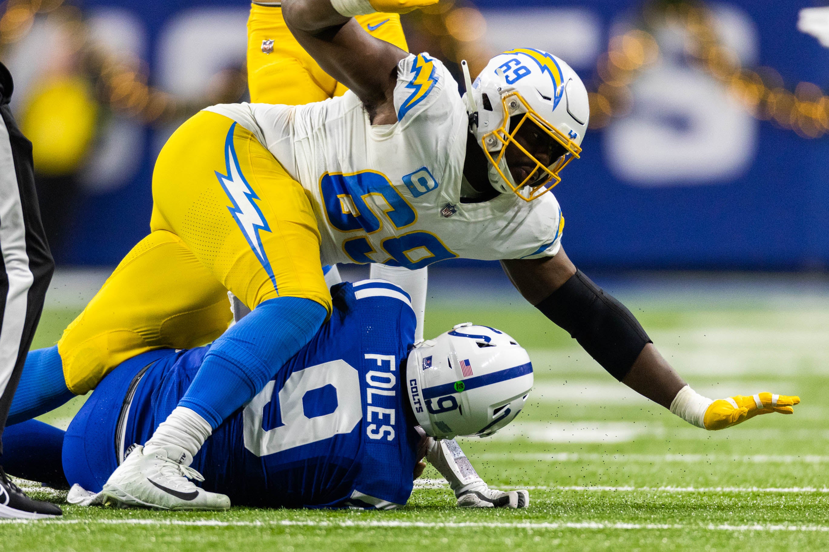Dec 26, 2022; Indianapolis, Indiana, USA; Los Angeles Chargers defensive tackle Sebastian Joseph-Day (69) sacks Indianapolis Colts quarterback Nick Foles (9) in the first half at Lucas Oil Stadium.