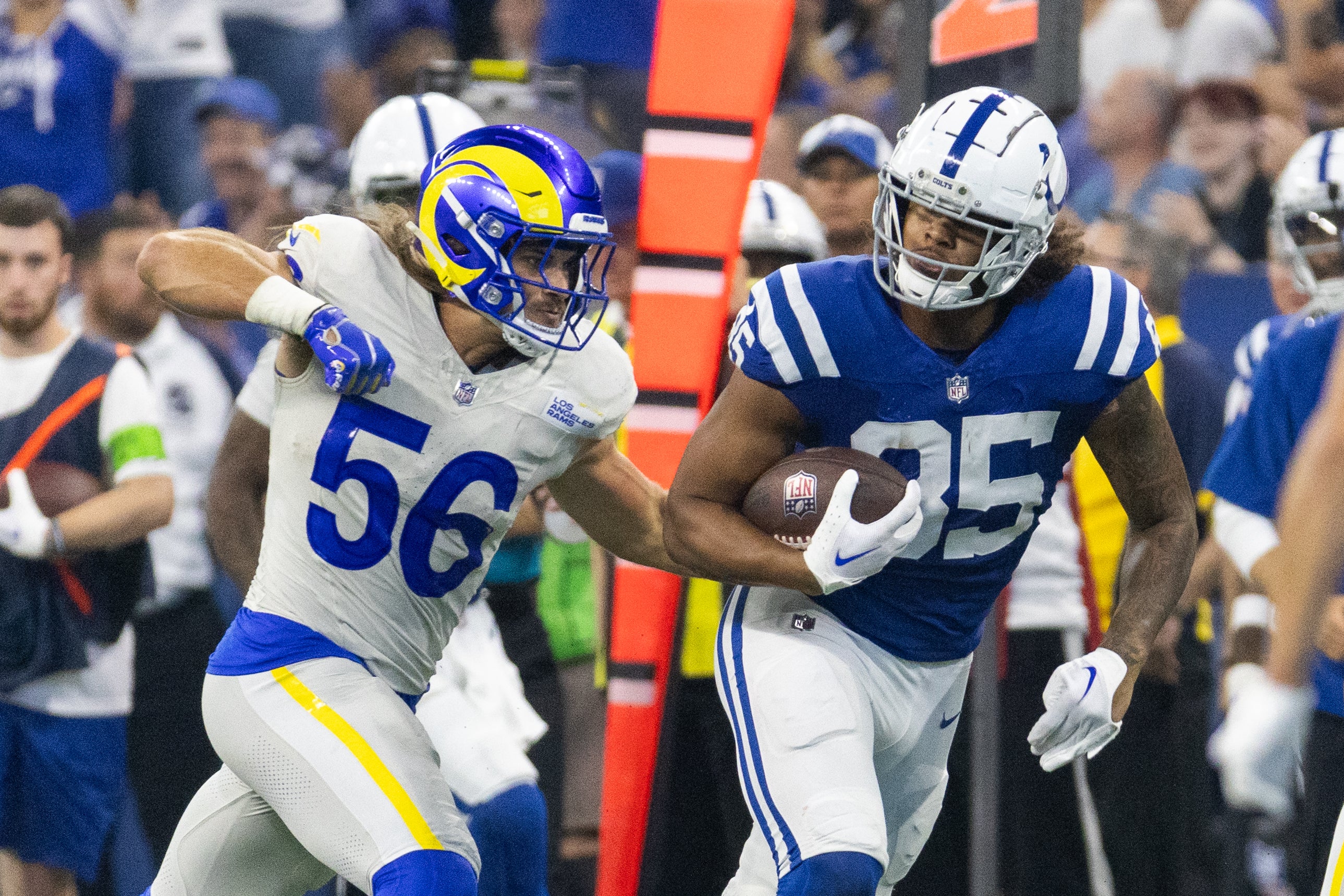 Oct 1, 2023; Indianapolis, Indiana, USA; Indianapolis Colts tight end Drew Ogletree (85) runs with the ball while Los Angeles Rams linebacker Christian Rozeboom (56) defends in the second half at Lucas Oil Stadium.