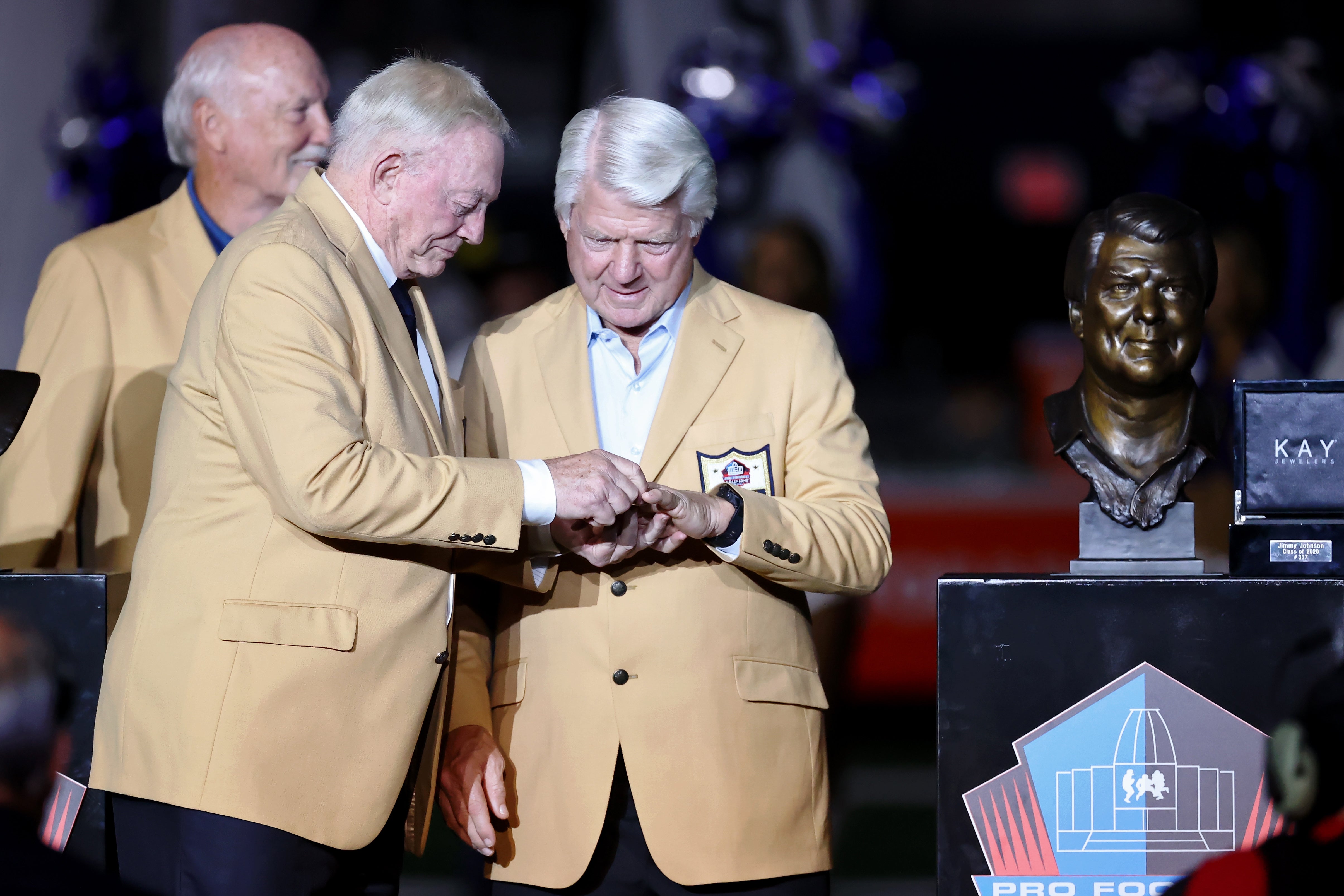 Jerry Jones puts the Hall of Fame ring on the finger of Jimmy Johnson during a presentation at halftime during the game between the Philadelphia Eagles and the Dallas Cowboys at AT&T Stadium.