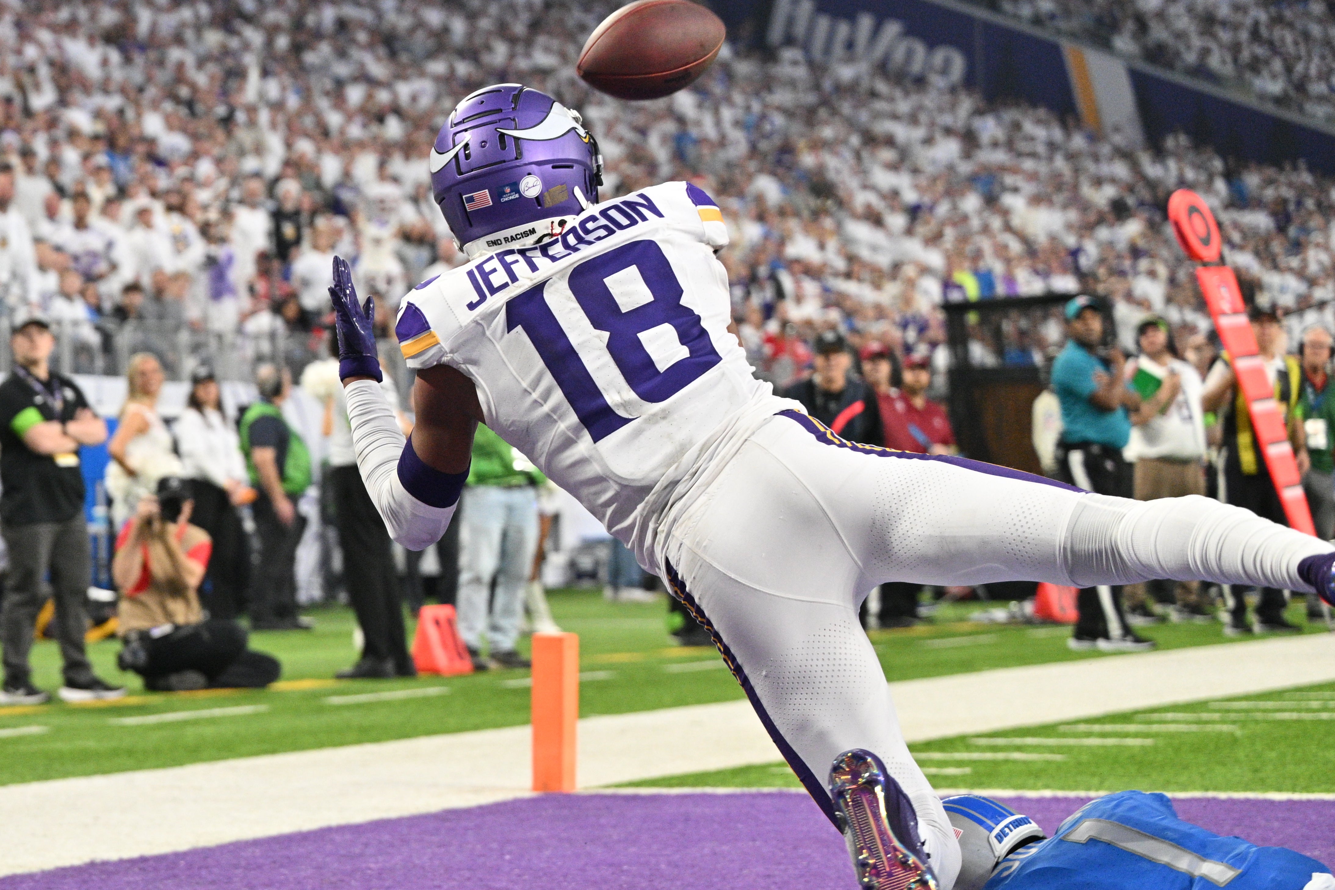 Dec 24, 2023; Minneapolis, Minnesota, USA; Minnesota Vikings wide receiver Justin Jefferson (18) catches a touchdown pass from quarterback Nick Mullens (not pictured) as Detroit Lions cornerback Cameron Sutton (1) defends during the second quarter at U.S. Bank Stadium. Mandatory Credit: Jeffrey Becker-USA TODAY Sports