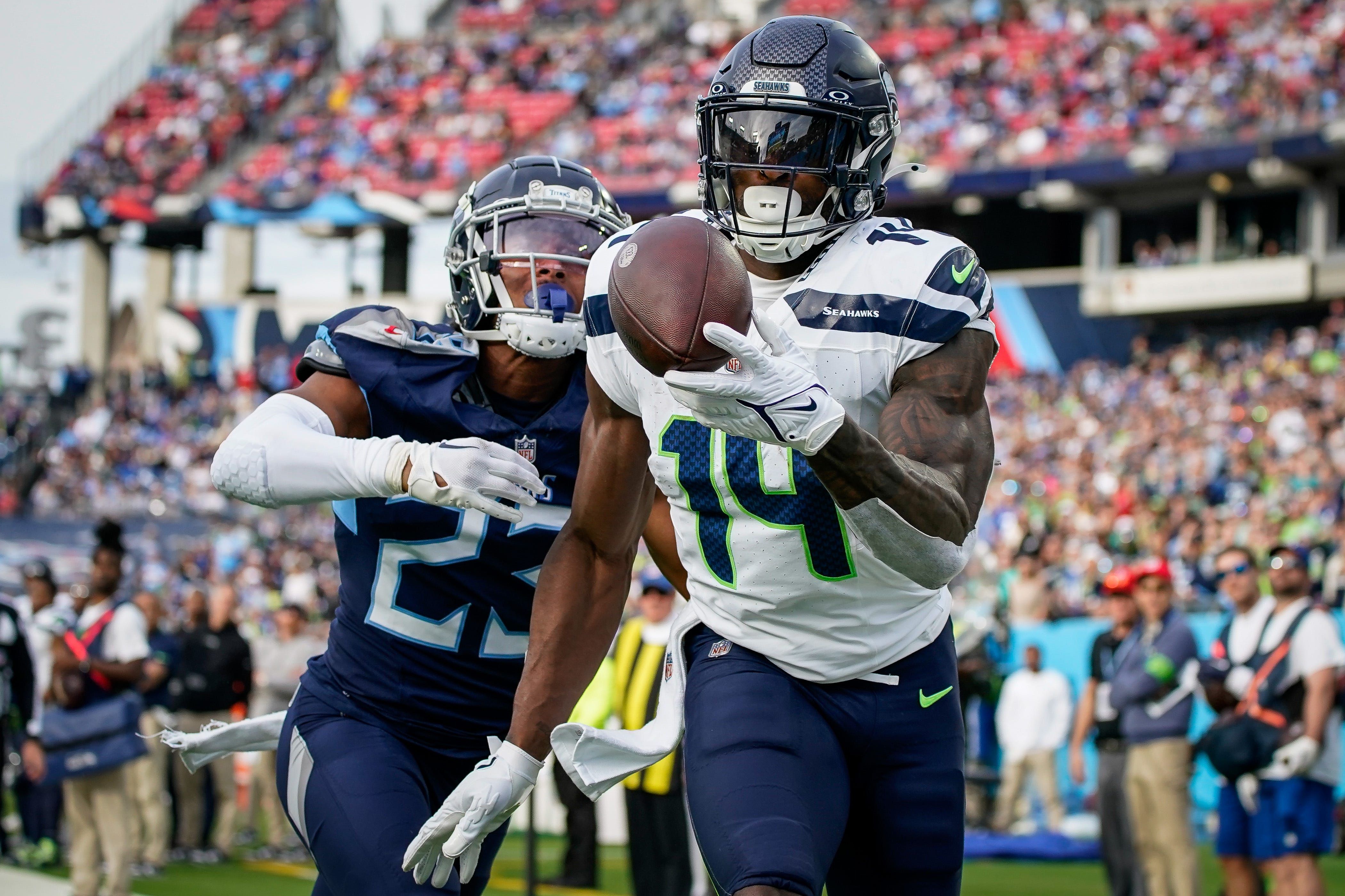 Seattle Seahawks wide receiver DK Metcalf (14) pulls in a touchdown past Tennessee Titans cornerback Tre Avery (23) during the fourth quarter at Nissan Stadium in Nashville, Tenn., Sunday, Dec. 24, 2023.