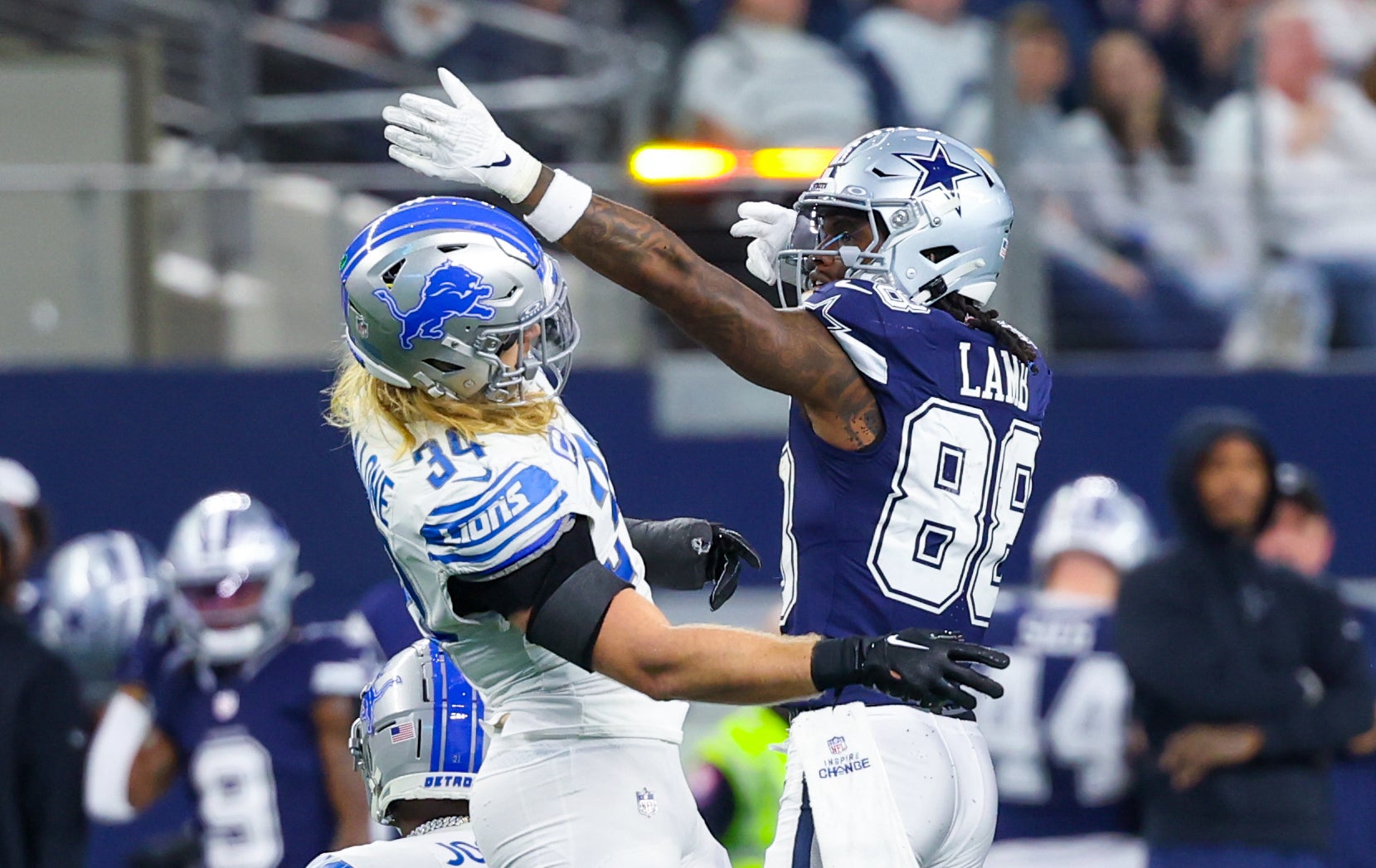 Dallas Cowboys wide receiver CeeDee Lamb (88) celebrates in front of Detroit Lions linebacker Alex Anzalone (34) during the second half at AT&T Stadium.