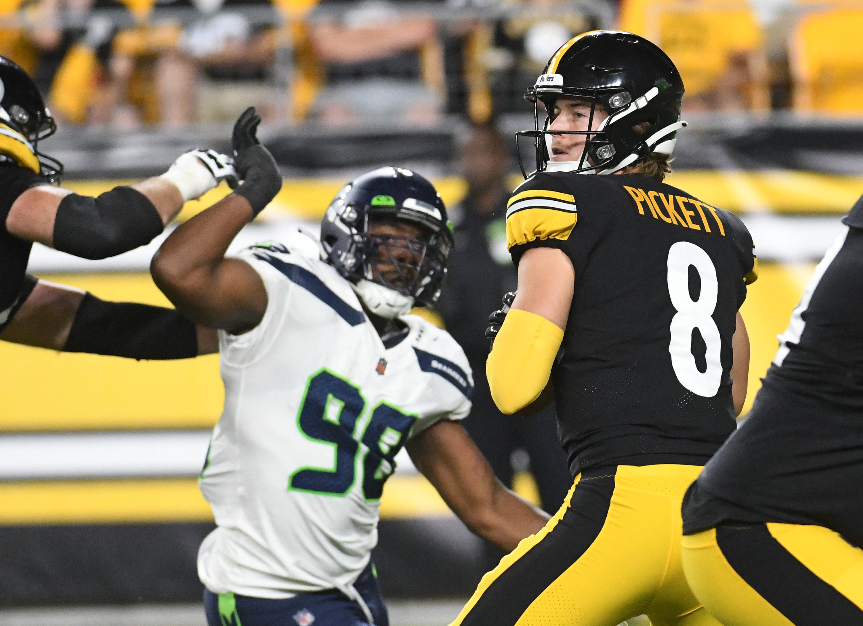 Aug 13, 2022; Pittsburgh, Pennsylvania, USA; Pittsburgh Steelers quarterback Kenny Pickett (8) is pressured by Seattle Seahawks defensive end Alton Robinson (98) during the third quarter at Acrisure Stadium. Mandatory Credit: Philip G. Pavely-USA TODAY Sports