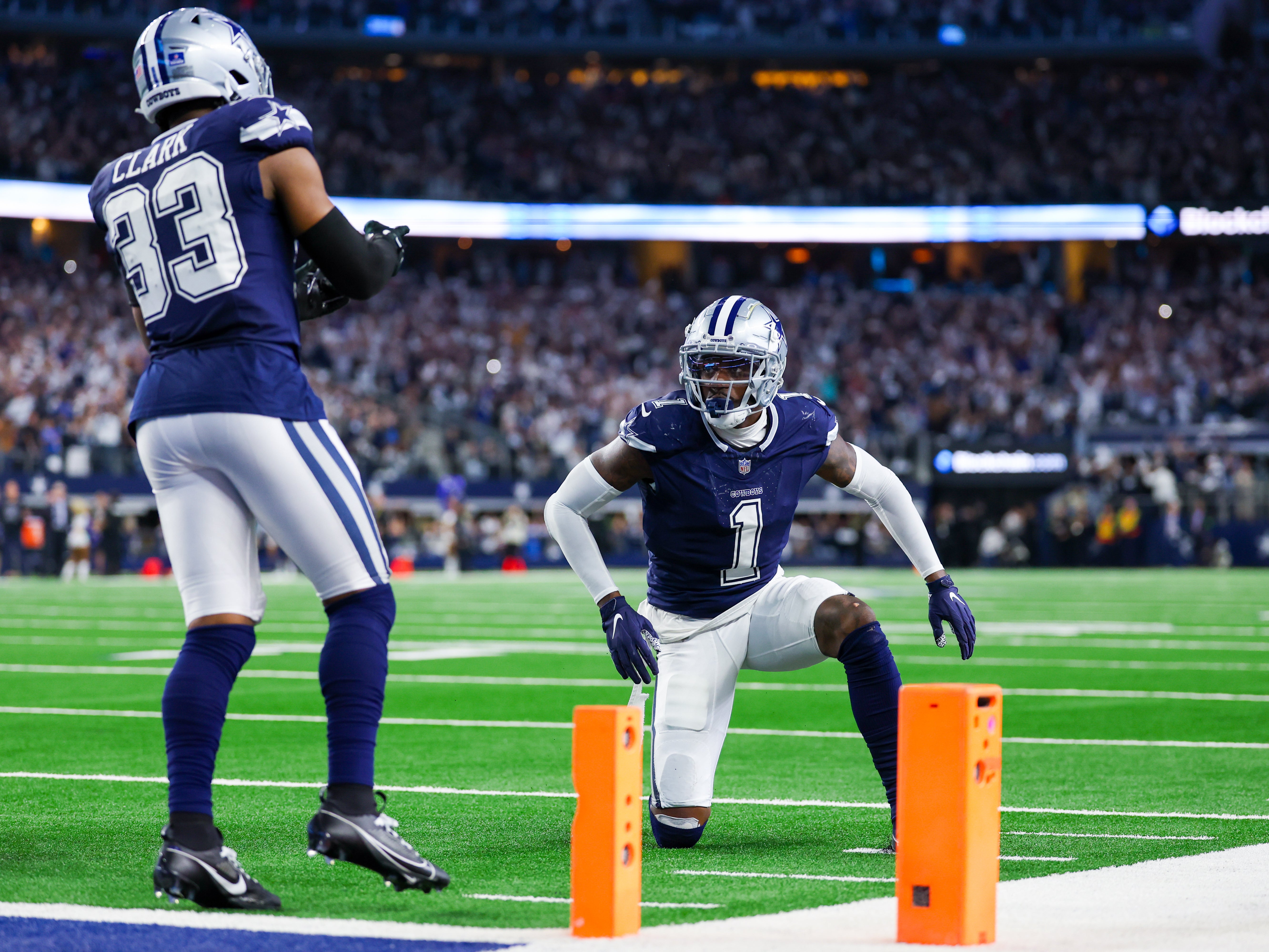 Dallas Cowboys safety Jayron Kearse (1) and Dallas Cowboys linebacker Damone Clark (33) celebrate after stopping a two point conversion against the Detroit Lions during the fourth quarter at AT&T Stadium.