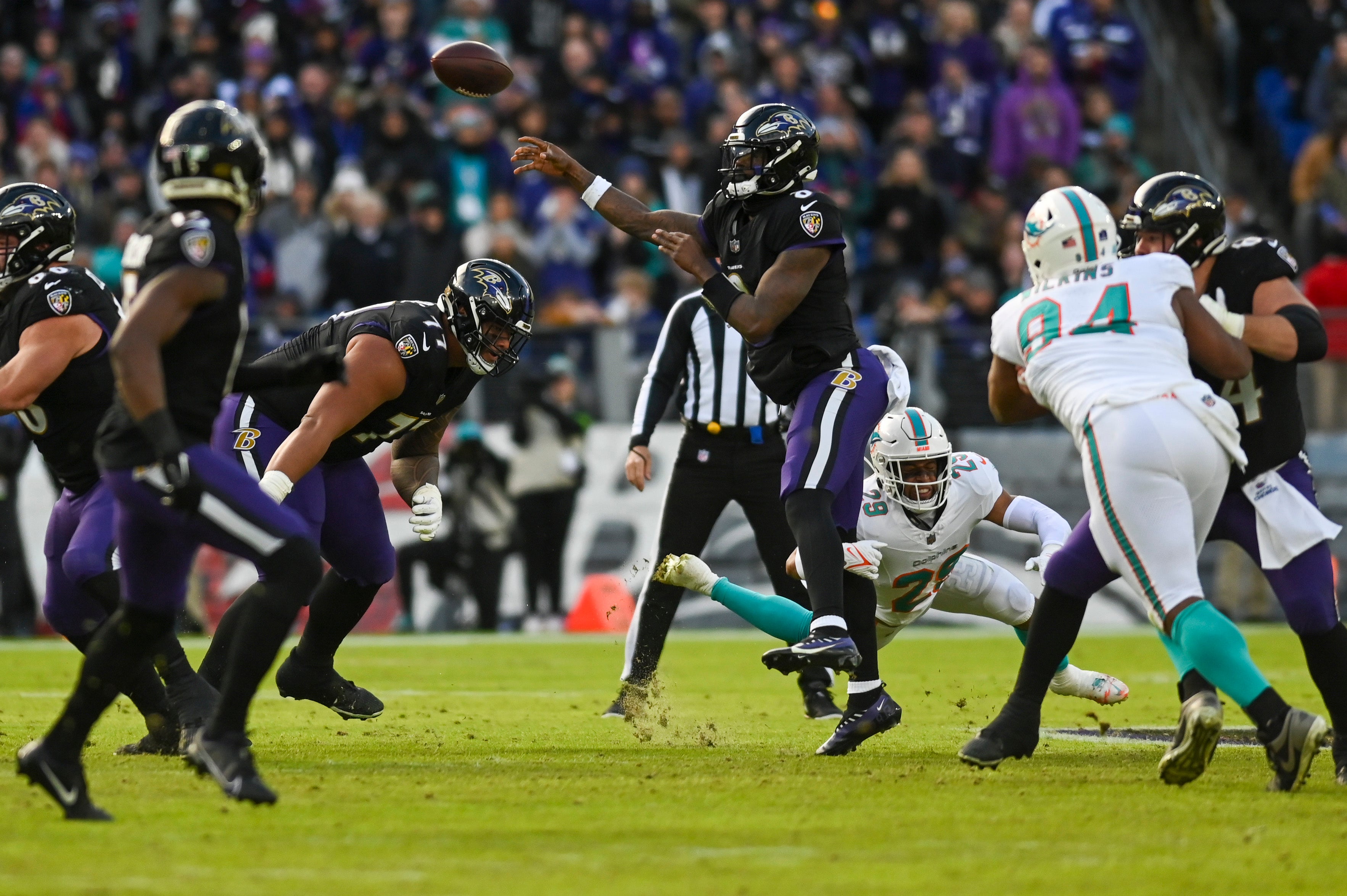 Baltimore Ravens quarterback Lamar Jackson (8) throws under pressure during the first half against the Miami Dolphins at M&T Bank Stadium.