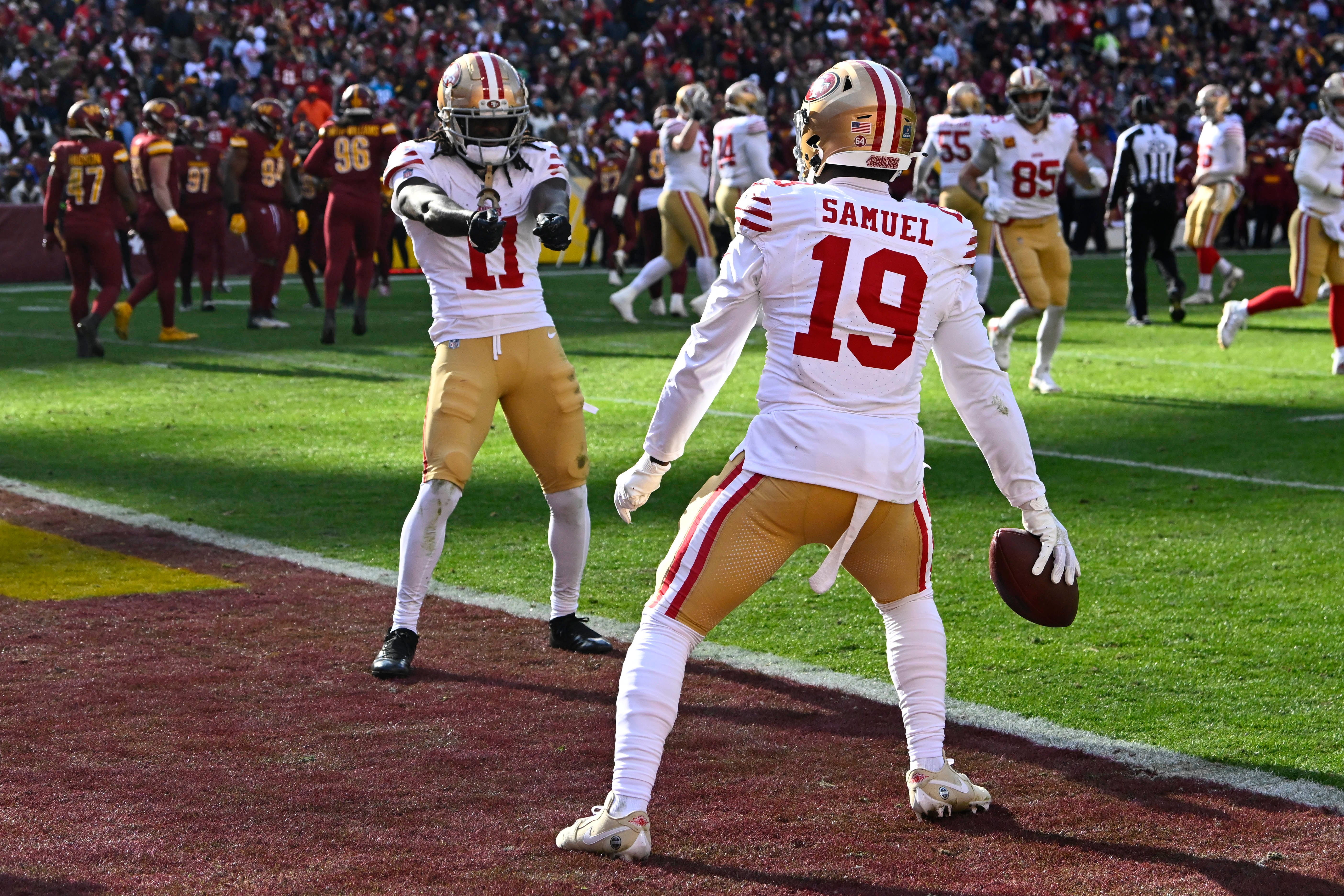 Dec 31, 2023; Landover, Maryland, USA; San Francisco 49ers wide receiver Deebo Samuel (19) celebrates with wide receiver Brandon Aiyuk (11) after scoring a touchdown against the Washington Commanders during the first half at FedExField.