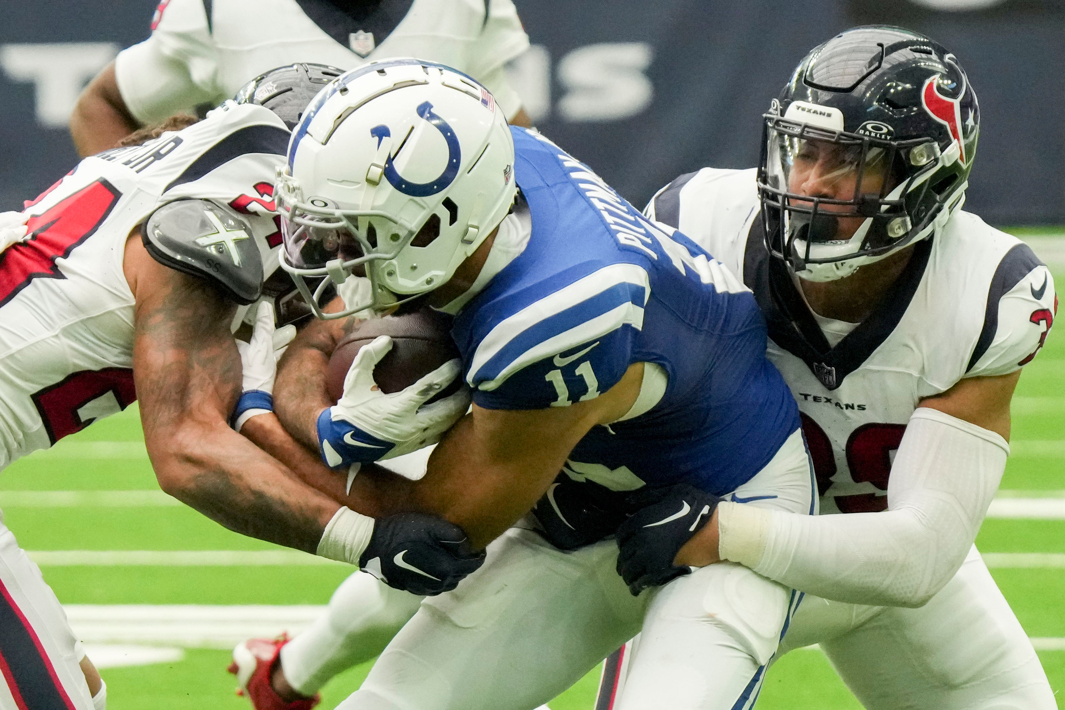Sep 17, 2023; Houston, Texas, USA; Houston Texans cornerback Derek Stingley Jr. (24) and linebacker Henry To'oTo'o (39) tackle Indianapolis Colts wide receiver Michael Pittman Jr. (11) at NRG Stadium.