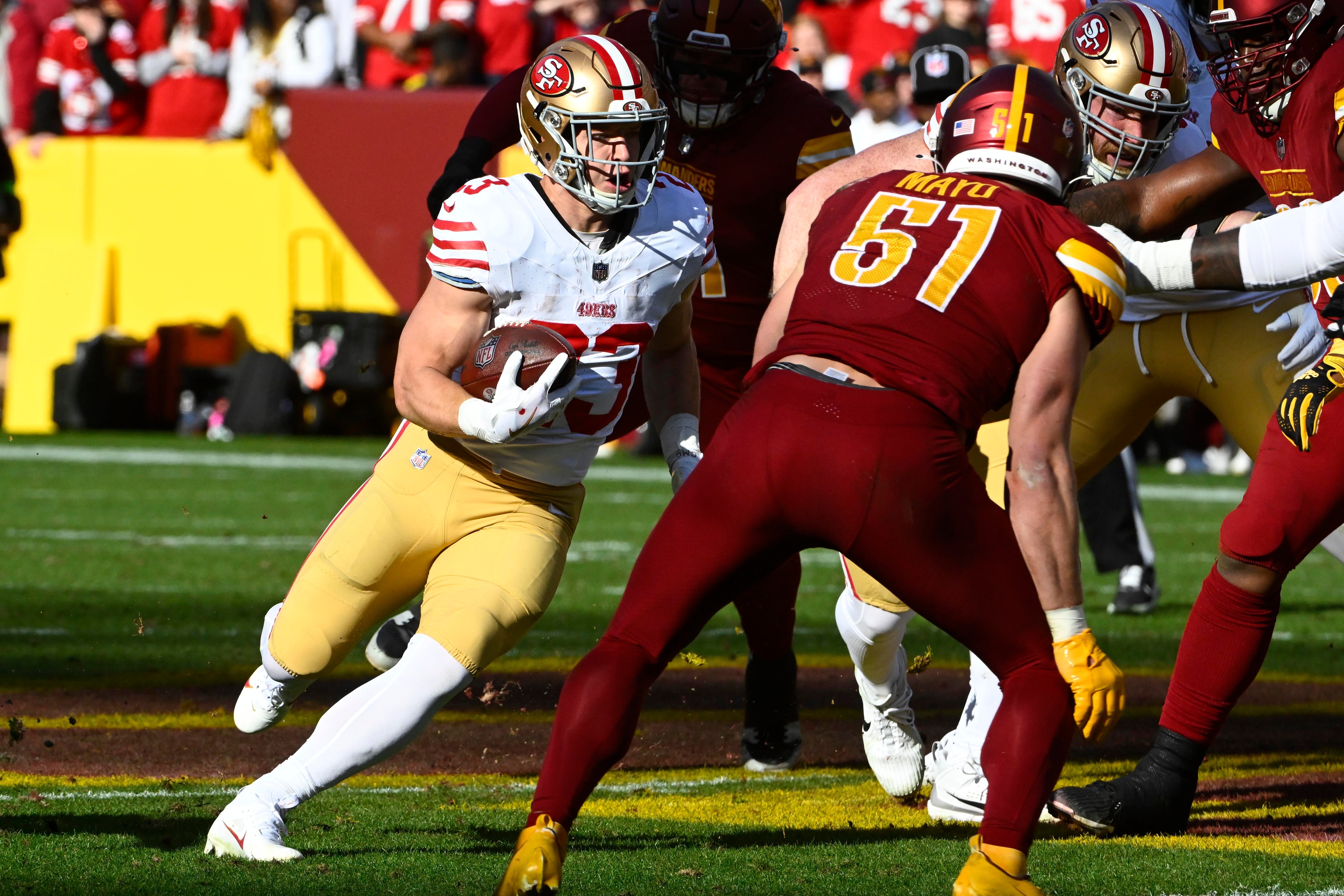 Dec 31, 2023; Landover, Maryland, USA; San Francisco 49ers running back Christian McCaffrey (23) carries the ball against the Washington Commanders during the first half at FedExField.