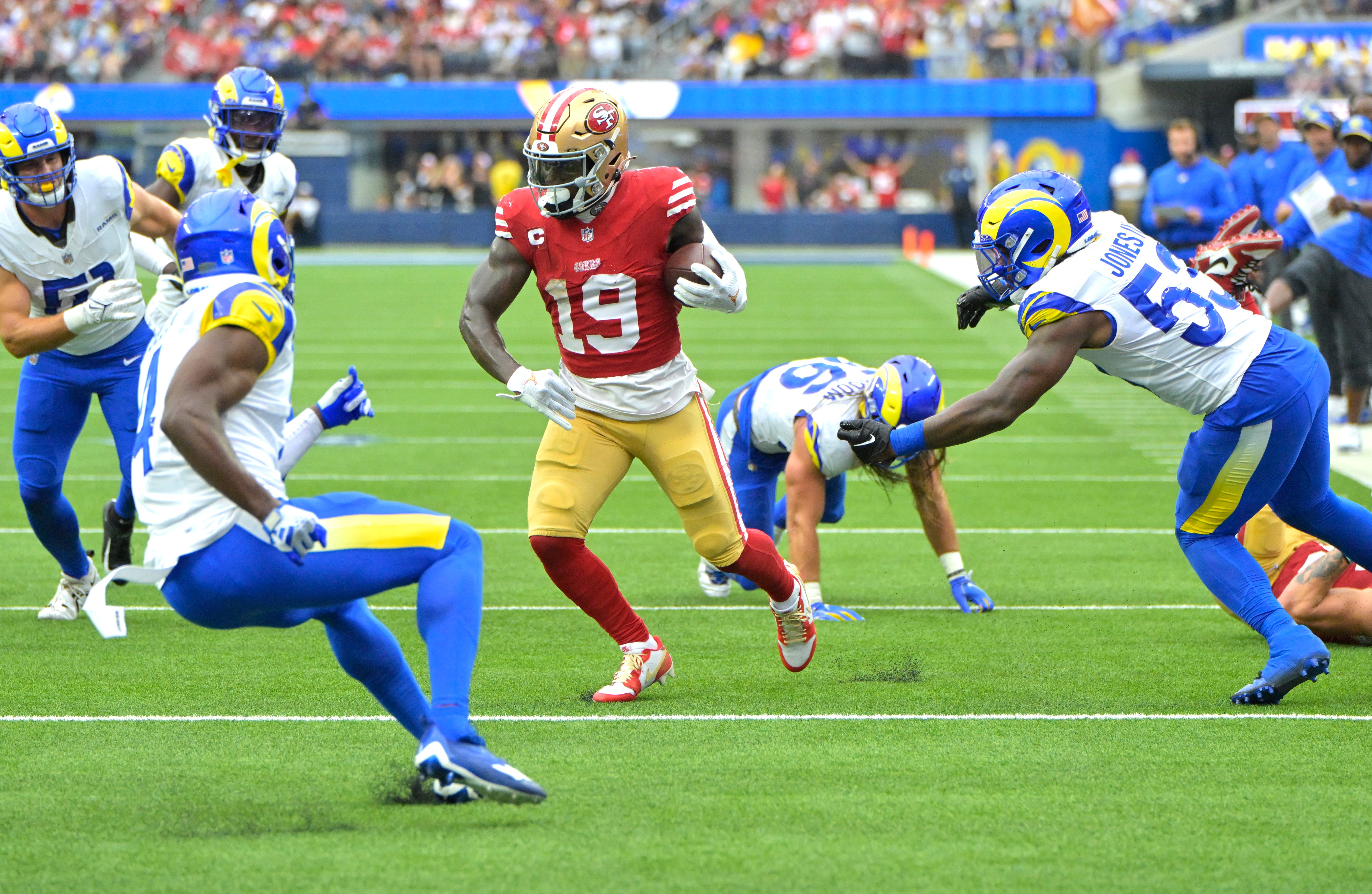 Sep 17, 2023; Inglewood, California, USA; San Francisco 49ers wide receiver Deebo Samuel (19) runs through the Los Angeles Rams defense for a touchdown in the second half at SoFi Stadium.