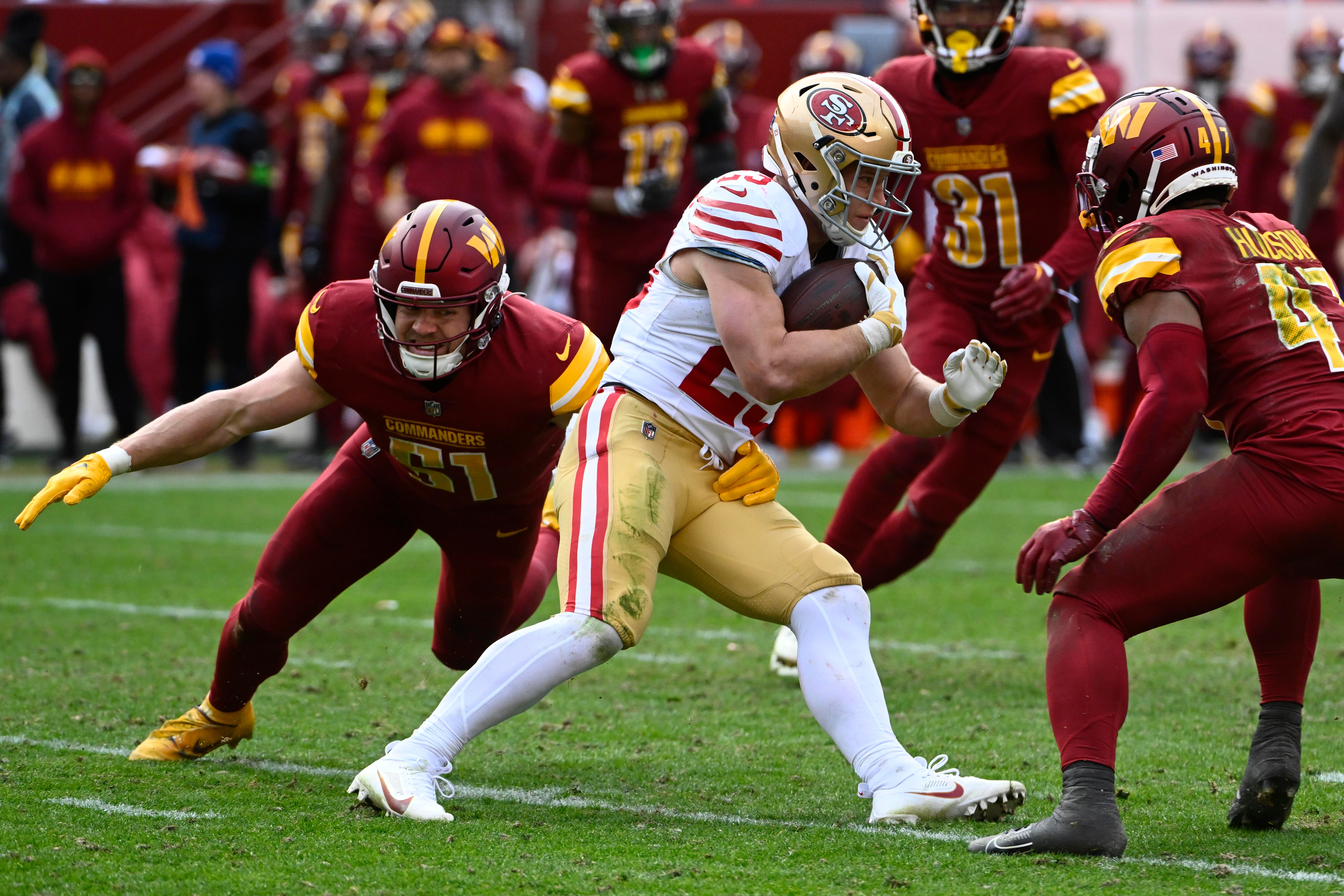Dec 31, 2023; Landover, Maryland, USA; San Francisco 49ers running back Christian McCaffrey (23) is tackled by Washington Commanders linebacker David Mayo (51) during the second half at FedExField.