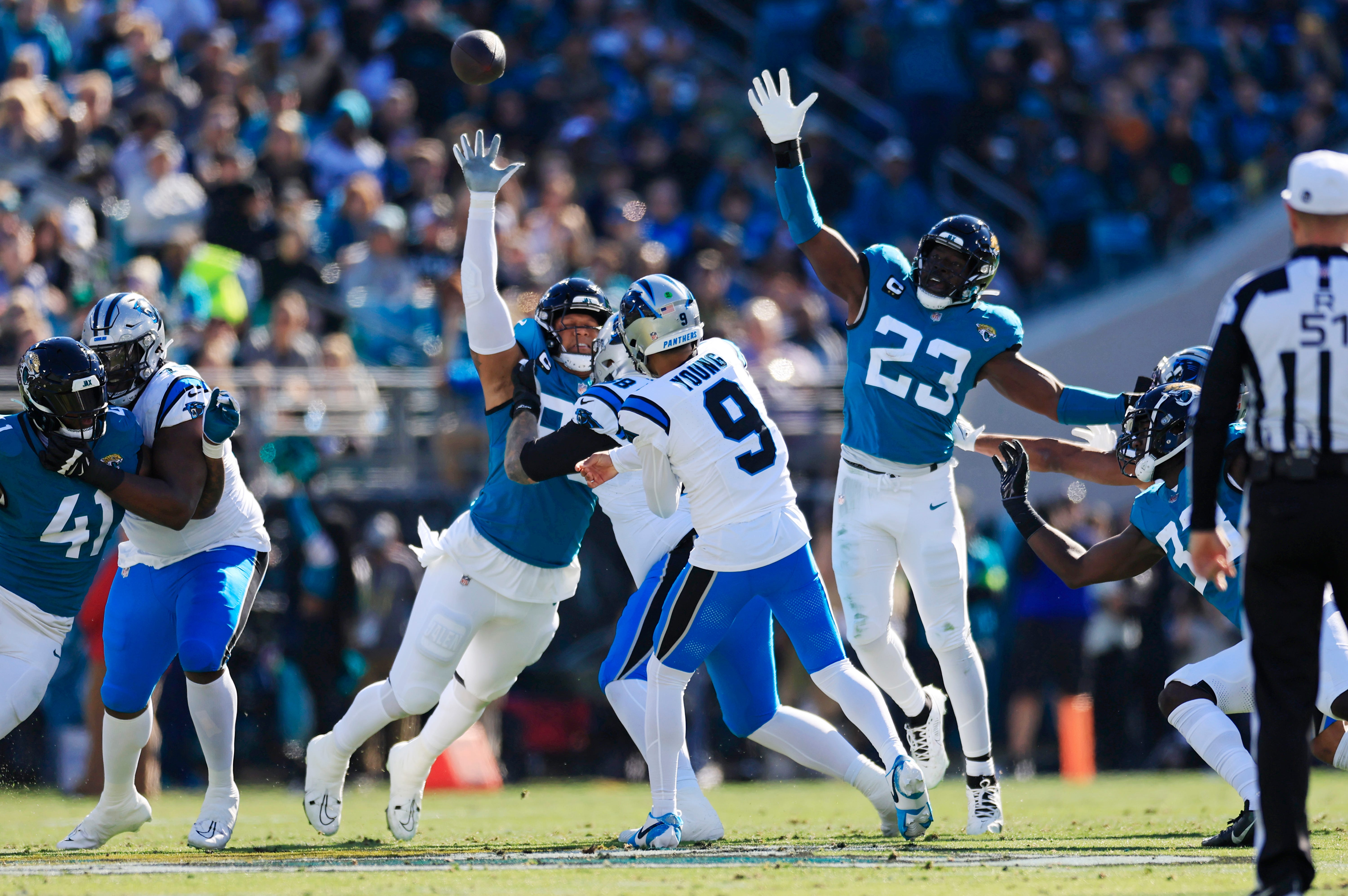 Carolina Panthers quarterback Bryce Young (9) touchback as Jacksonville Jaguars defensive end Roy Robertson-Harris (95) and linebacker Foyesade Oluokun (23) defend during the first quarter of a regular season NFL football matchup Sunday, Dec. 31, 2023 at EverBank Stadium in Jacksonville, Fla. The Jacksonville Jaguars blanked the Carolina Panthers 26-0. [Corey Perrine/Florida Times-Union]