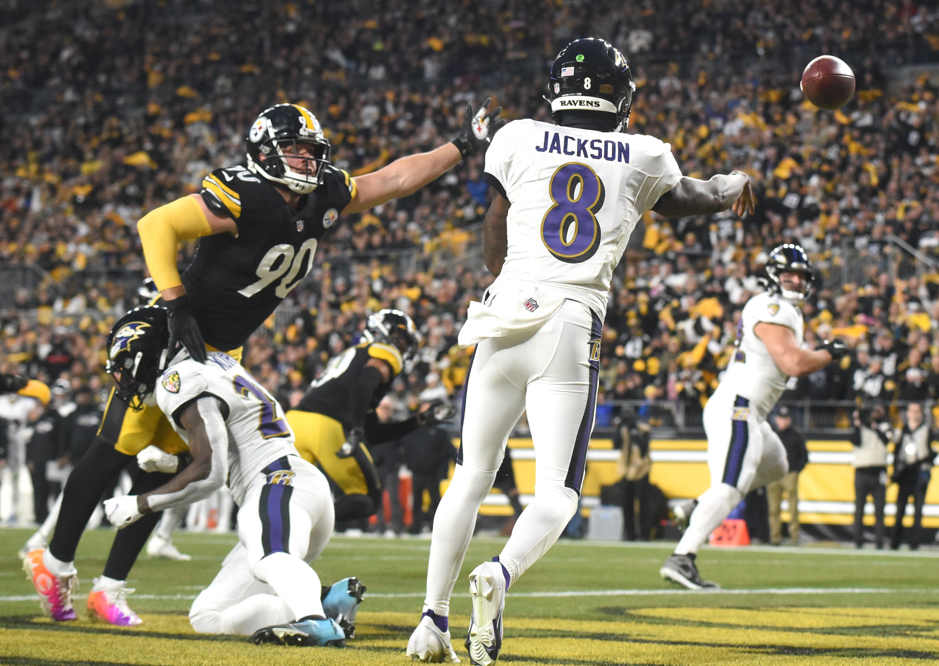 Dec 5, 2021; Pittsburgh, Pennsylvania, USA; Baltimore Ravens quarterback Lamar Jackson (8) throws a second quarter pass under pressure from Pittsburgh Steelers linebacker T.J. Watt (90) at Heinz Field. Mandatory Credit: Philip G. Pavely-USA TODAY Sports  