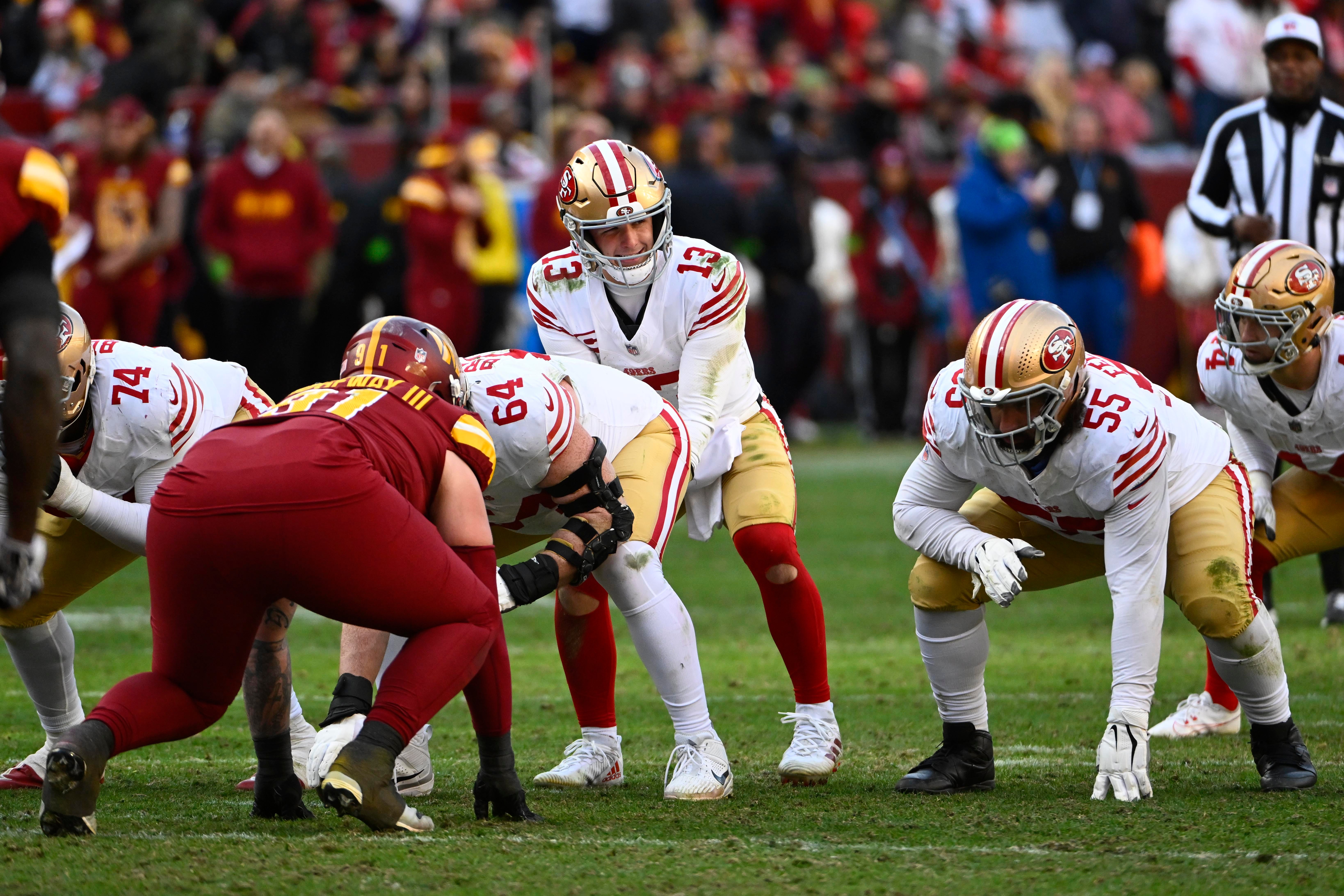 Dec 31, 2023; Landover, Maryland, USA; San Francisco 49ers quarterback Brock Purdy (13) at the line of scrimmage against the Washington Commanders during the second half at FedExField.