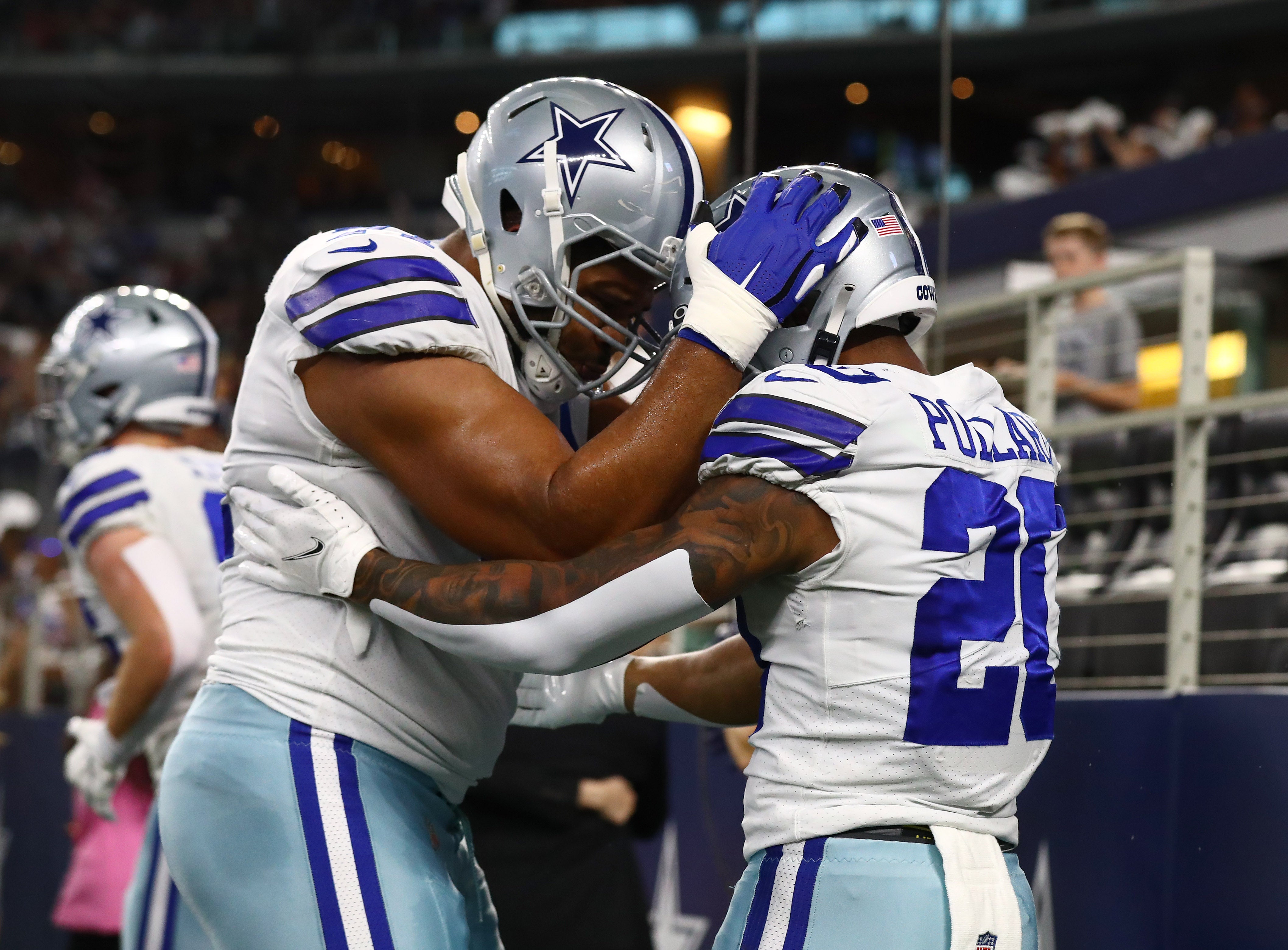 Dallas Cowboys running back Tony Pollard (20) celebrates a first quarter touchdown with tackle La'el Collins (71) against the Houston Texans at AT&T Stadium.