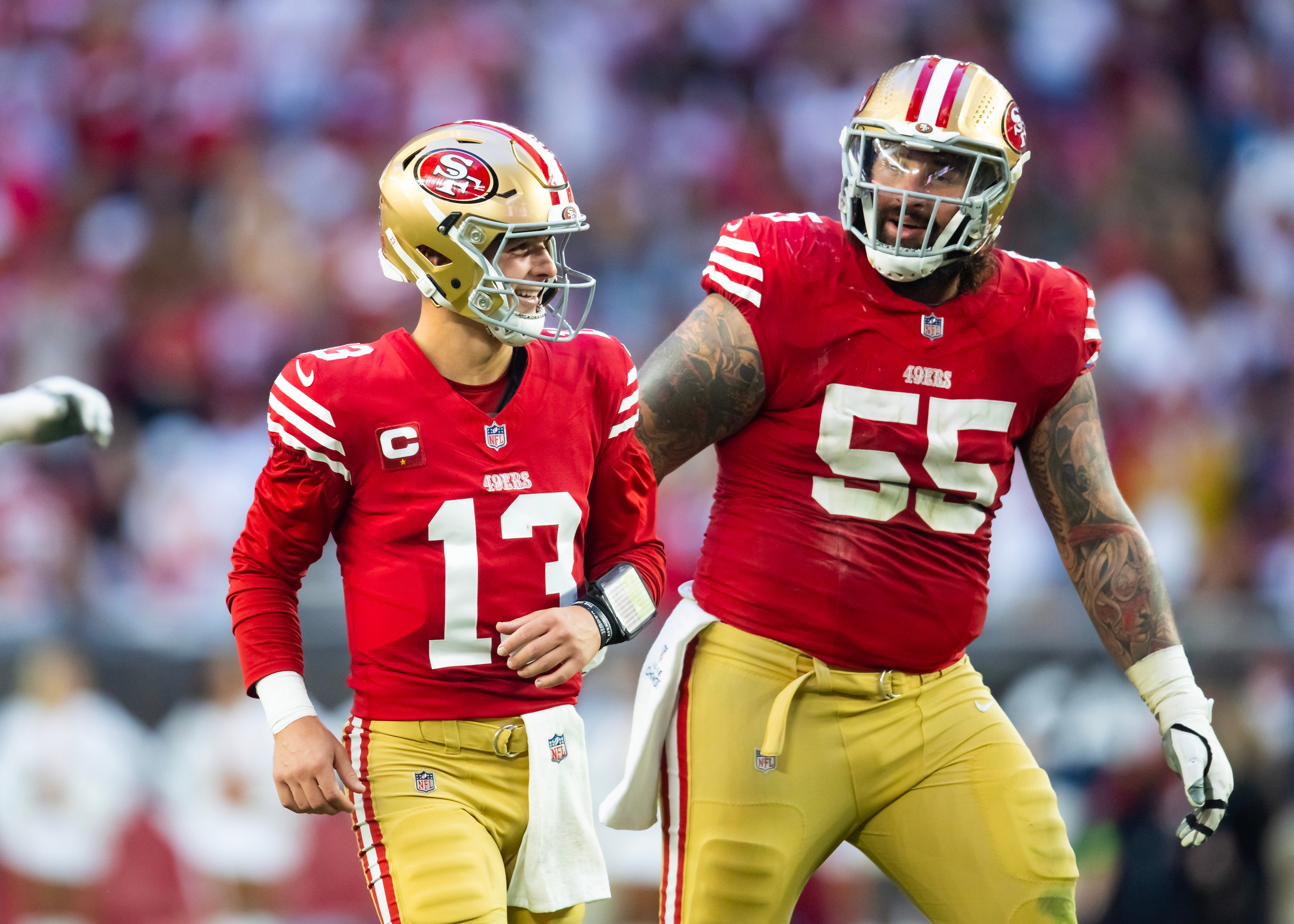 Dec 17, 2023; Glendale, Arizona, USA; San Francisco 49ers quarterback Brock Purdy (13) celebrates a touchdown with guard Jon Feliciano (55) against the Arizona Cardinals at State Farm Stadium.