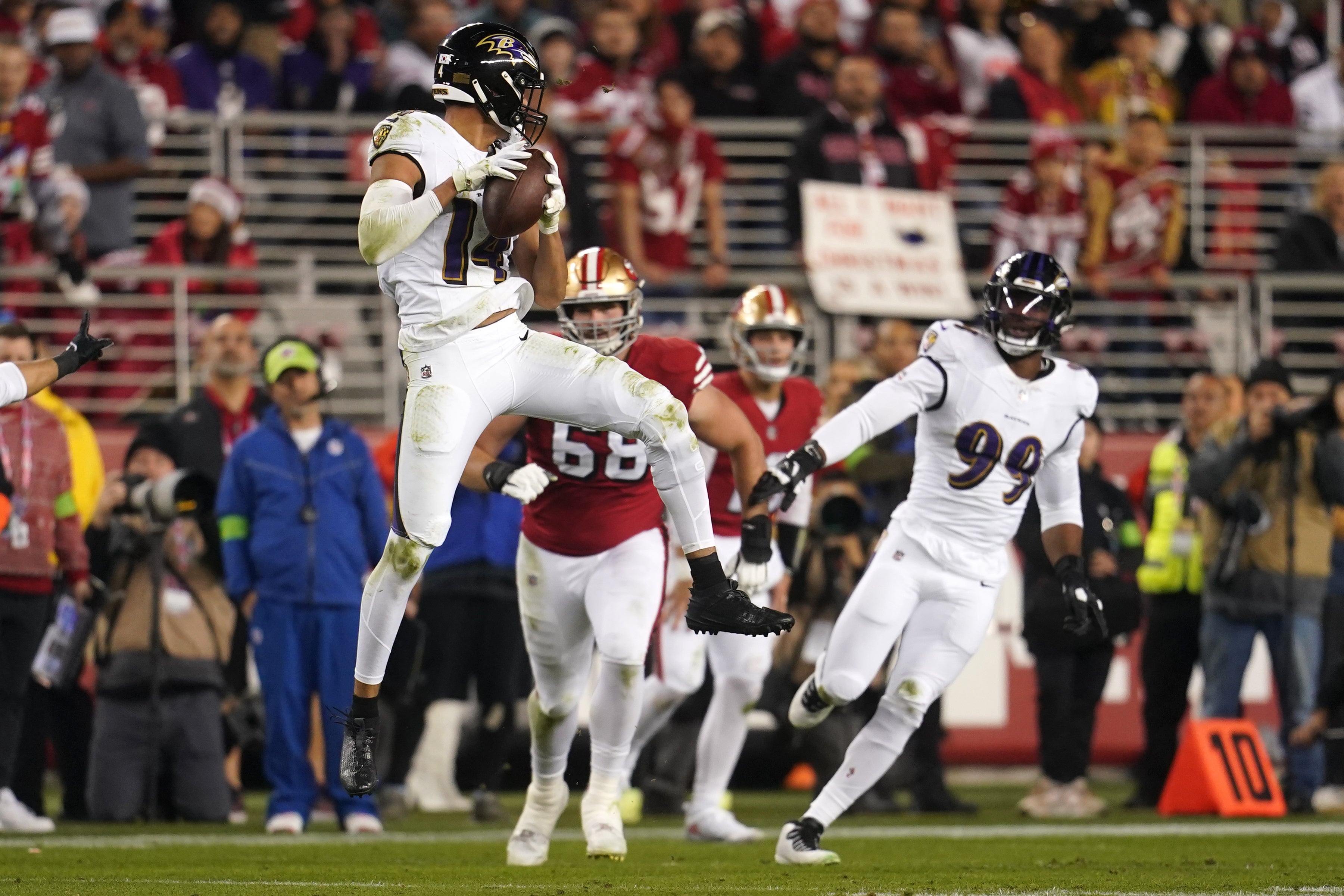 Baltimore Ravens safety Kyle Hamilton (14) intercepts a pass against the San Francisco 49ers in the second quarter at Levi's Stadium.