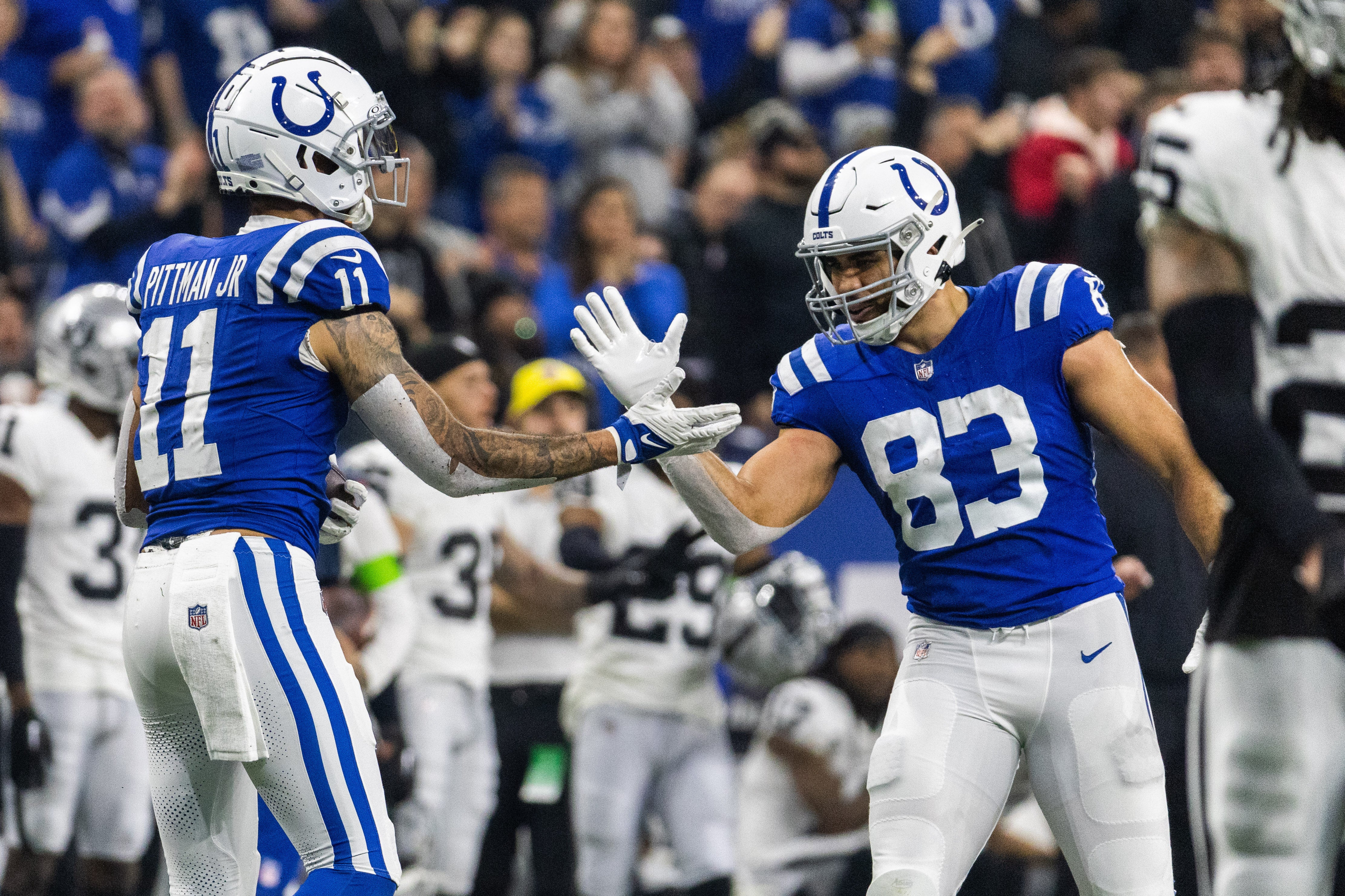 Dec 31, 2023; Indianapolis, Indiana, USA; Indianapolis Colts wide receiver Michael Pittman Jr. (11) and tight end Kylen Granson (83) celebrate a first down in the second half against the Las Vegas Raiders at Lucas Oil Stadium.
