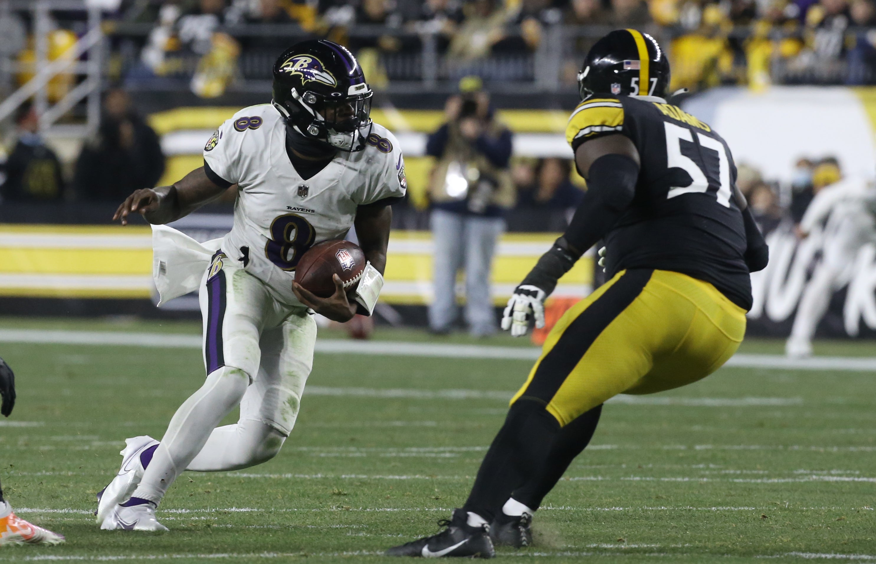 Dec 5, 2021; Pittsburgh, Pennsylvania, USA; Baltimore Ravens quarterback Lamar Jackson (8) carries the ball as Pittsburgh Steelers defensive tackle Montravius Adams (57) defends during the second quarter at Heinz Field. Mandatory Credit: Charles LeClaire-USA TODAY Sports  