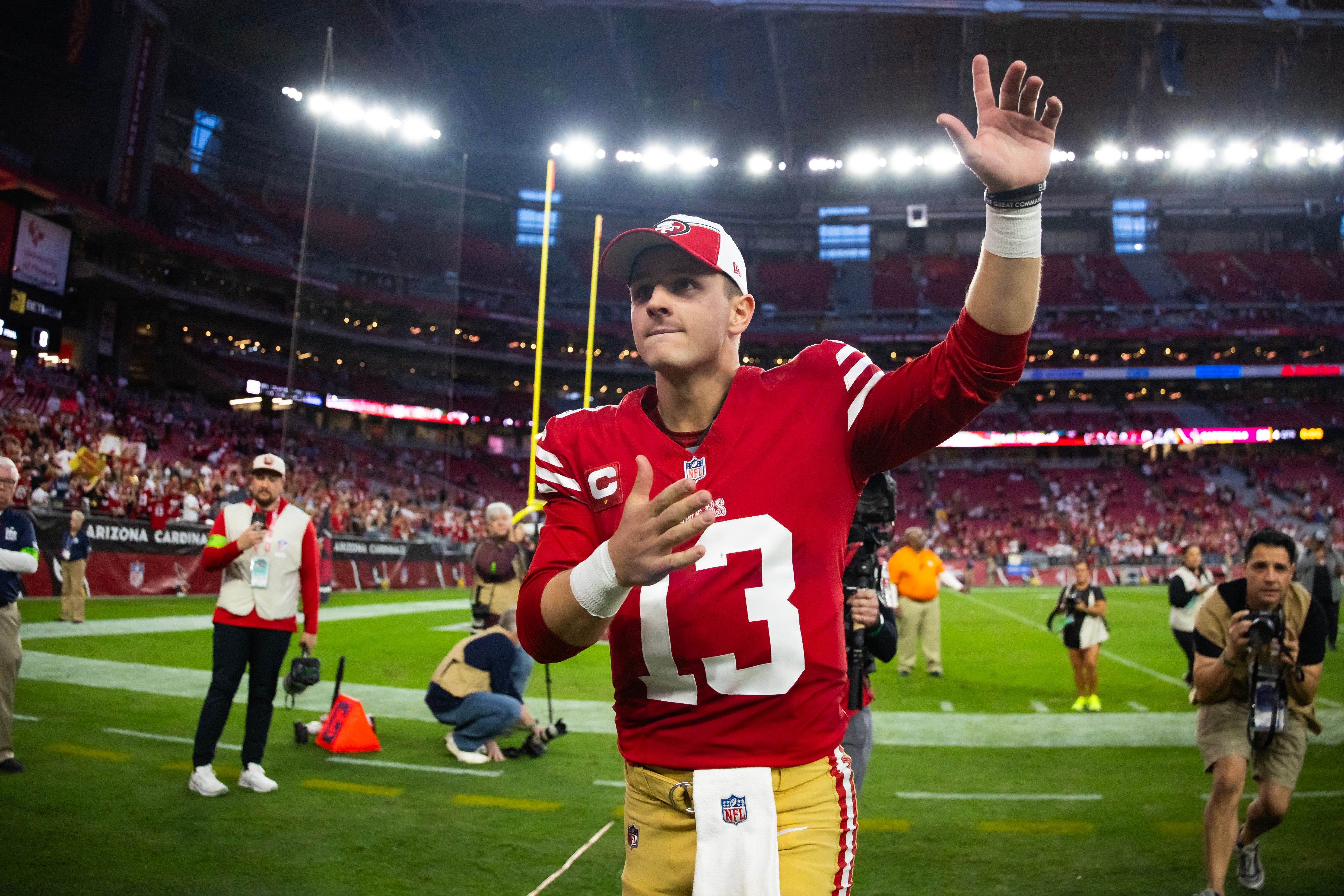 Dec 17, 2023; Glendale, Arizona, USA; San Francisco 49ers quarterback Brock Purdy (13) celebrates following the game against the Arizona Cardinals at State Farm Stadium.