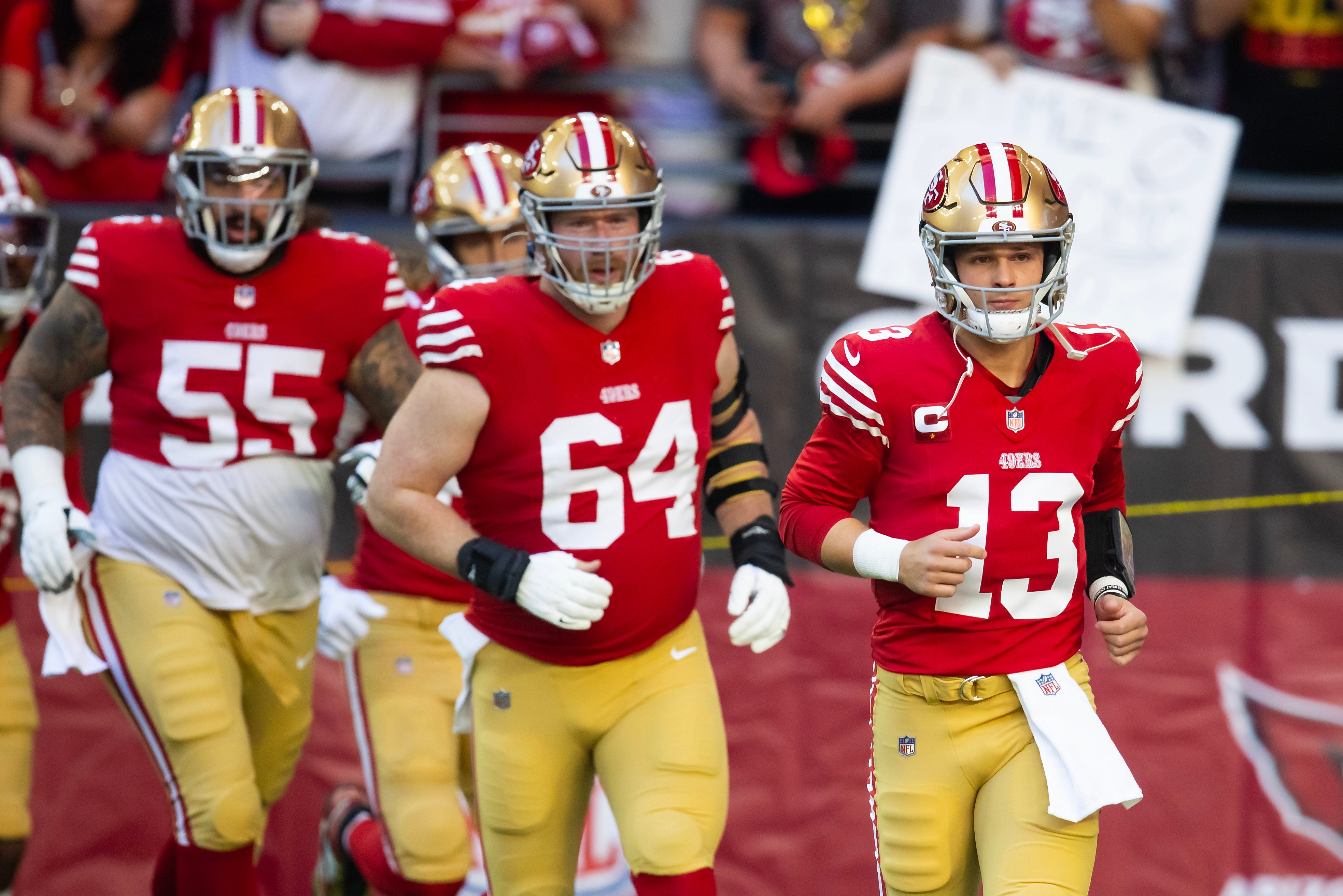 Dec 17, 2023; Glendale, Arizona, USA; San Francisco 49ers quarterback Brock Purdy (13) with center Jake Brendel (64) and guard Jon Feliciano (55) against the Arizona Cardinals at State Farm Stadium.