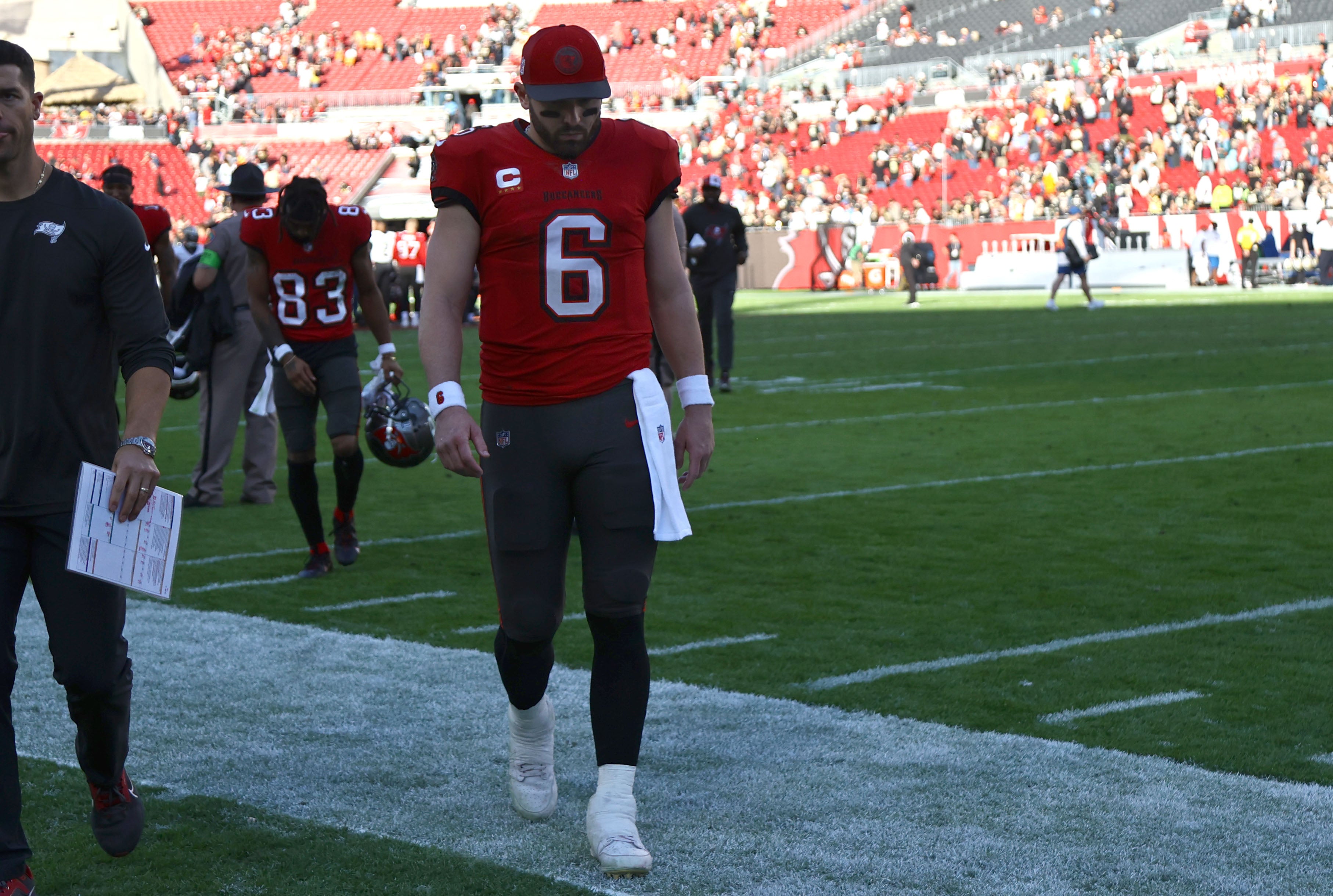 Dec 31, 2023; Tampa, Florida, USA; Tampa Bay Buccaneers quarterback Baker Mayfield (6) looks down as he walks off the field after they lost to the New Orleans Saints at Raymond James Stadium. Mandatory Credit: Kim Klement Neitzel-USA TODAY Sports