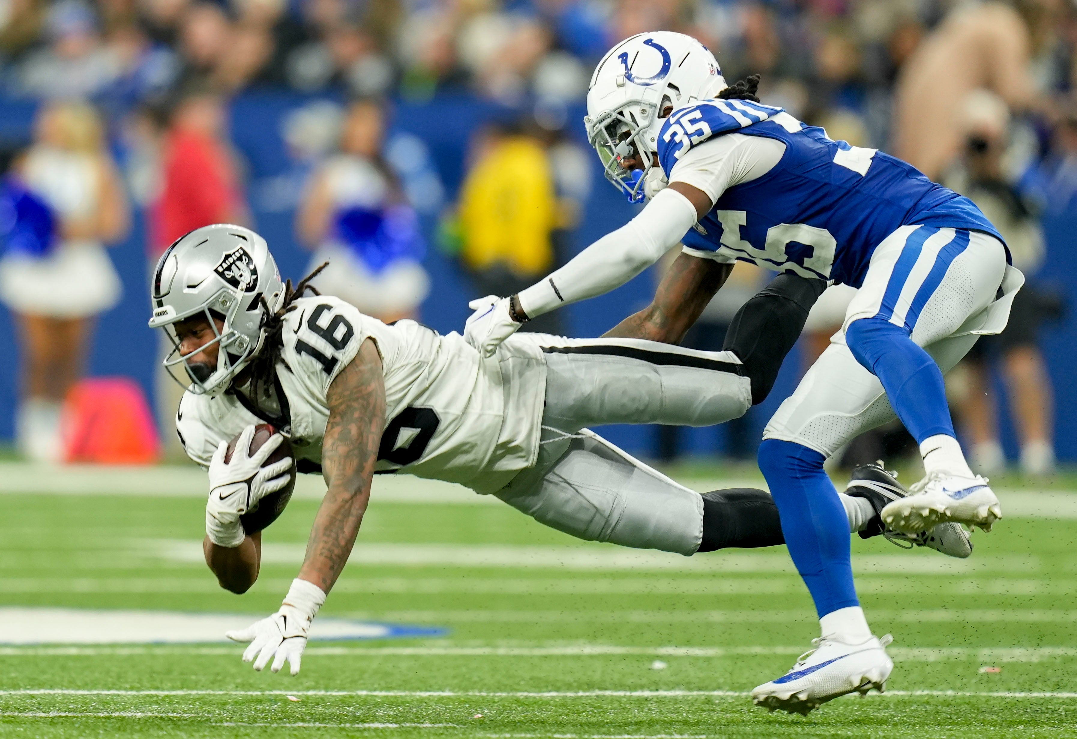 Dec 31, 2023; Indianapolis, Indiana, USA; Indianapolis Colts cornerback Chris Lammons (35) dives after Las Vegas Raiders wide receiver Jakobi Meyers (16) during a game against the Las Vegas Raiders at Lucas Oil Stadium.
