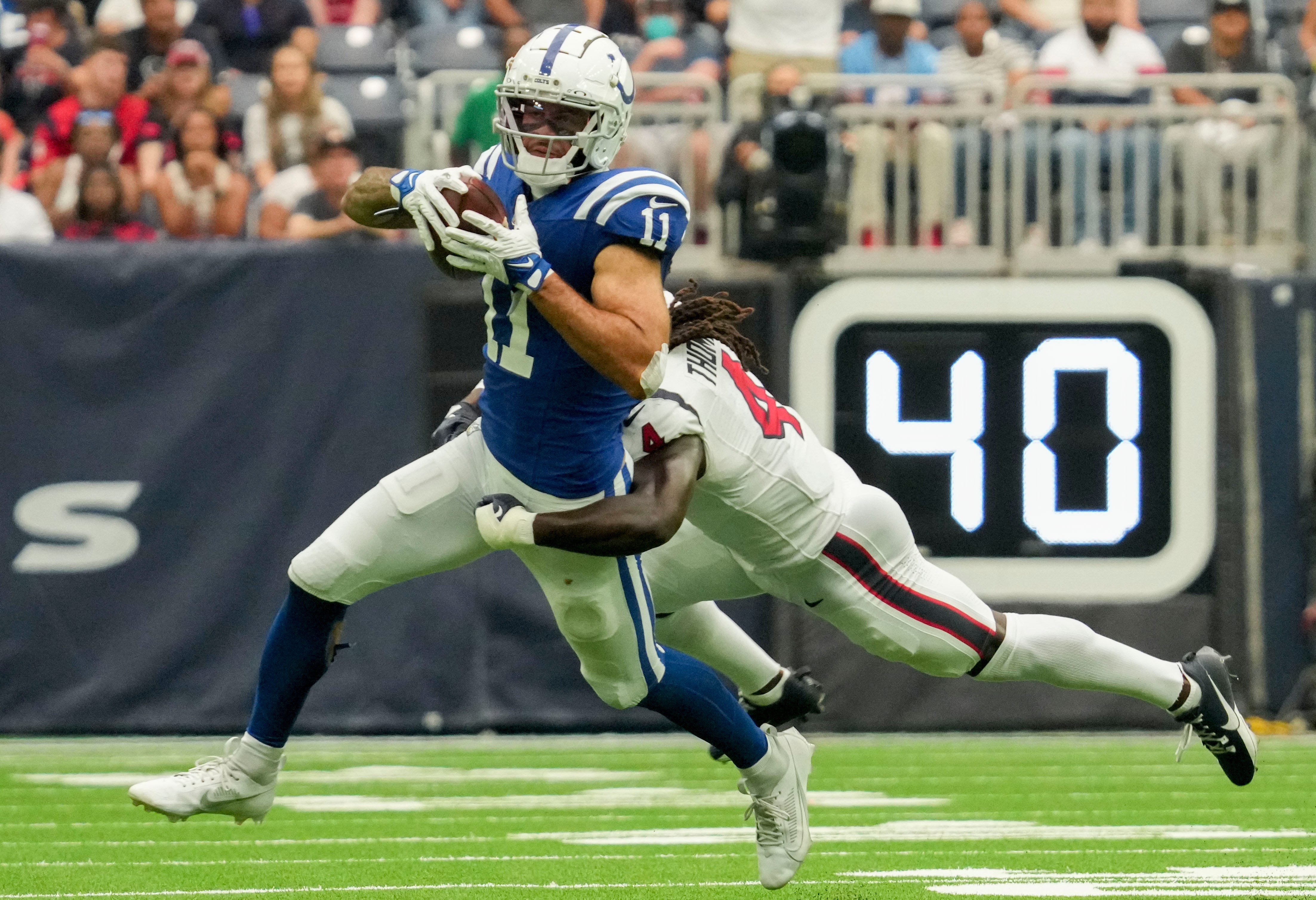 Houston Texans cornerback Tavierre Thomas (4) works to bring down Indianapolis Colts wide receiver Michael Pittman Jr. (11) on Sunday, Sept. 17, 2023, during a game against the Houston Texans at NRG Stadium in Houston