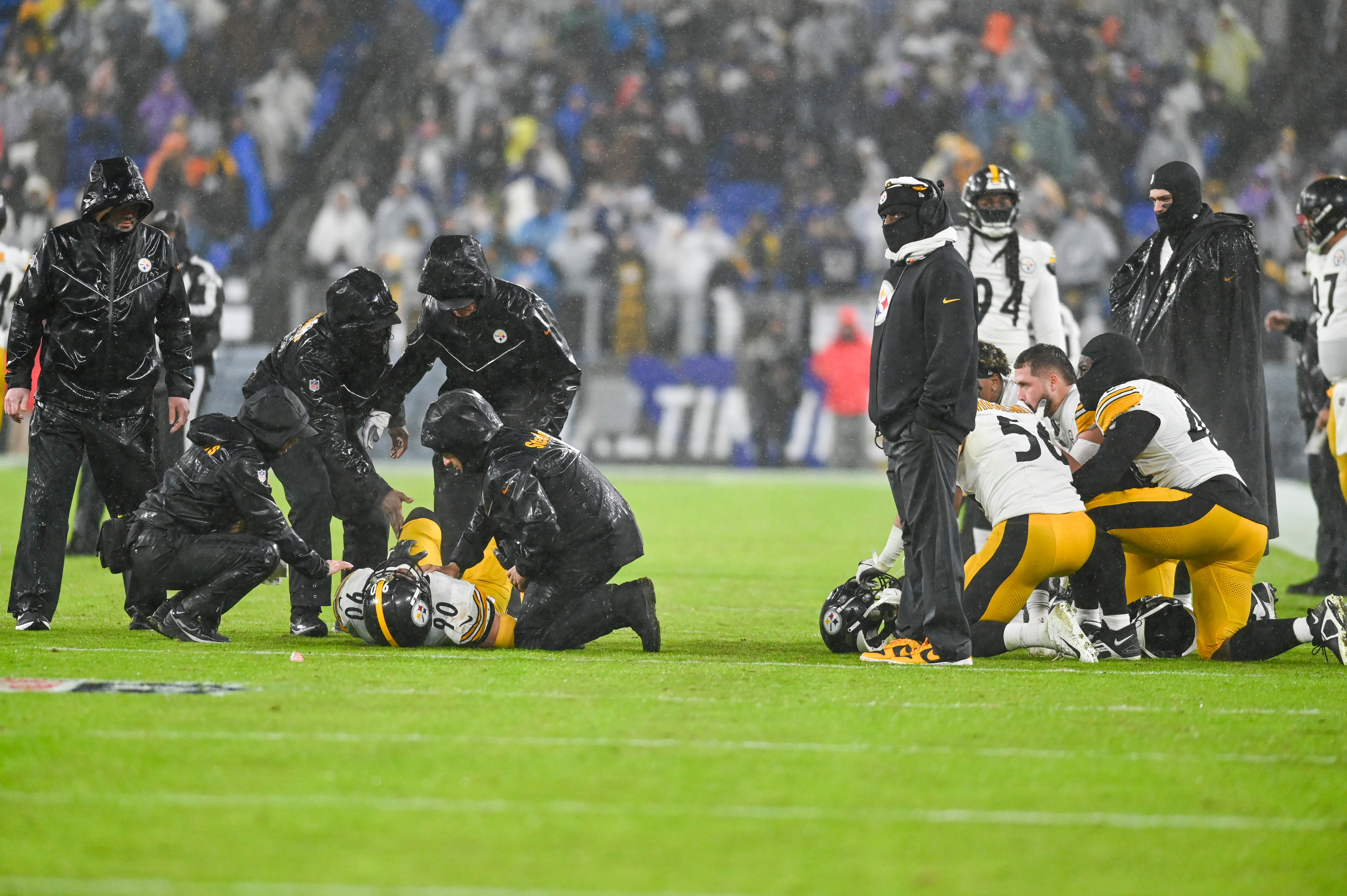 Jan 6, 2024; Baltimore, Maryland, USA; Pittsburgh Steelers medical staff tend to inebacker T.J. Watt (left) as teammates take a knee during the third quarter against the Baltimore Ravens at M&T Bank Stadium. Mandatory Credit: Tommy Gilligan-USA TODAY Sports