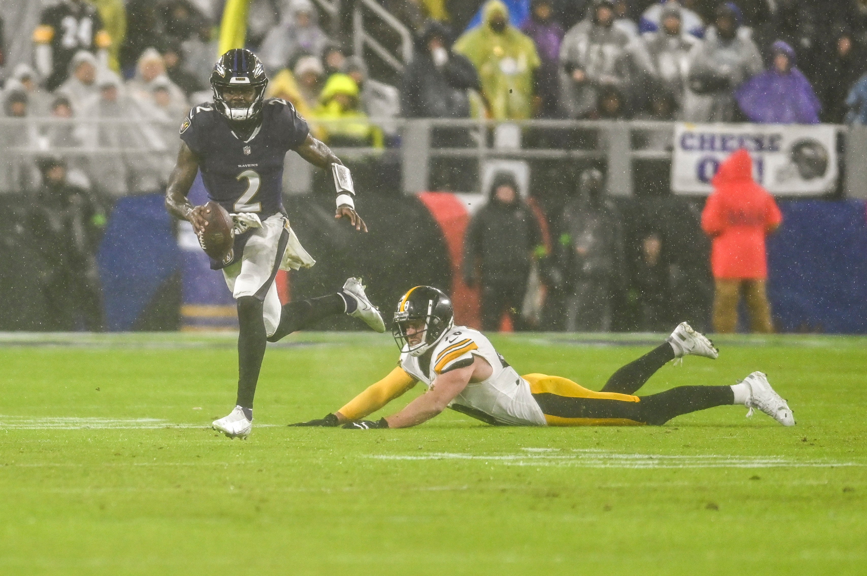Jan 6, 2024; Baltimore, Maryland, USA; Baltimore Ravens quarterback Tyler Huntley (2) rushes past Pittsburgh Steelers linebacker T.J. Watt (90) during the first half at M&T Bank Stadium. Mandatory Credit: Tommy Gilligan-USA TODAY Sports  