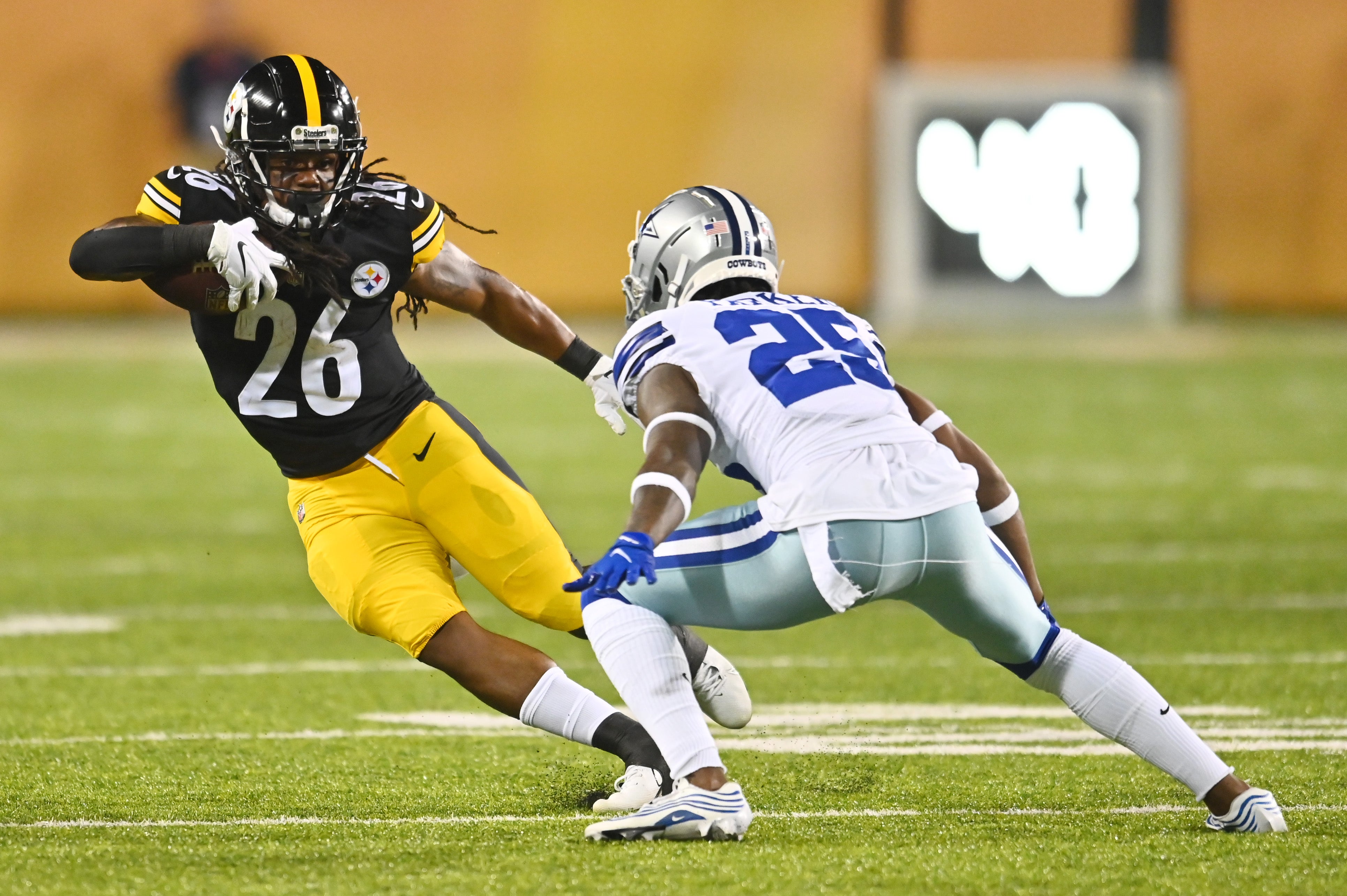 Aug 5, 2021; Canton, Ohio, USA; Pittsburgh Steelers running back Anthony McFarland (26) runs the ball against Dallas Cowboys defensive back Steven Parker (25) during the second half at Tom Benson Hall of Fame Stadium. Mandatory Credit: Ken Blaze-USA TODAY Sports  