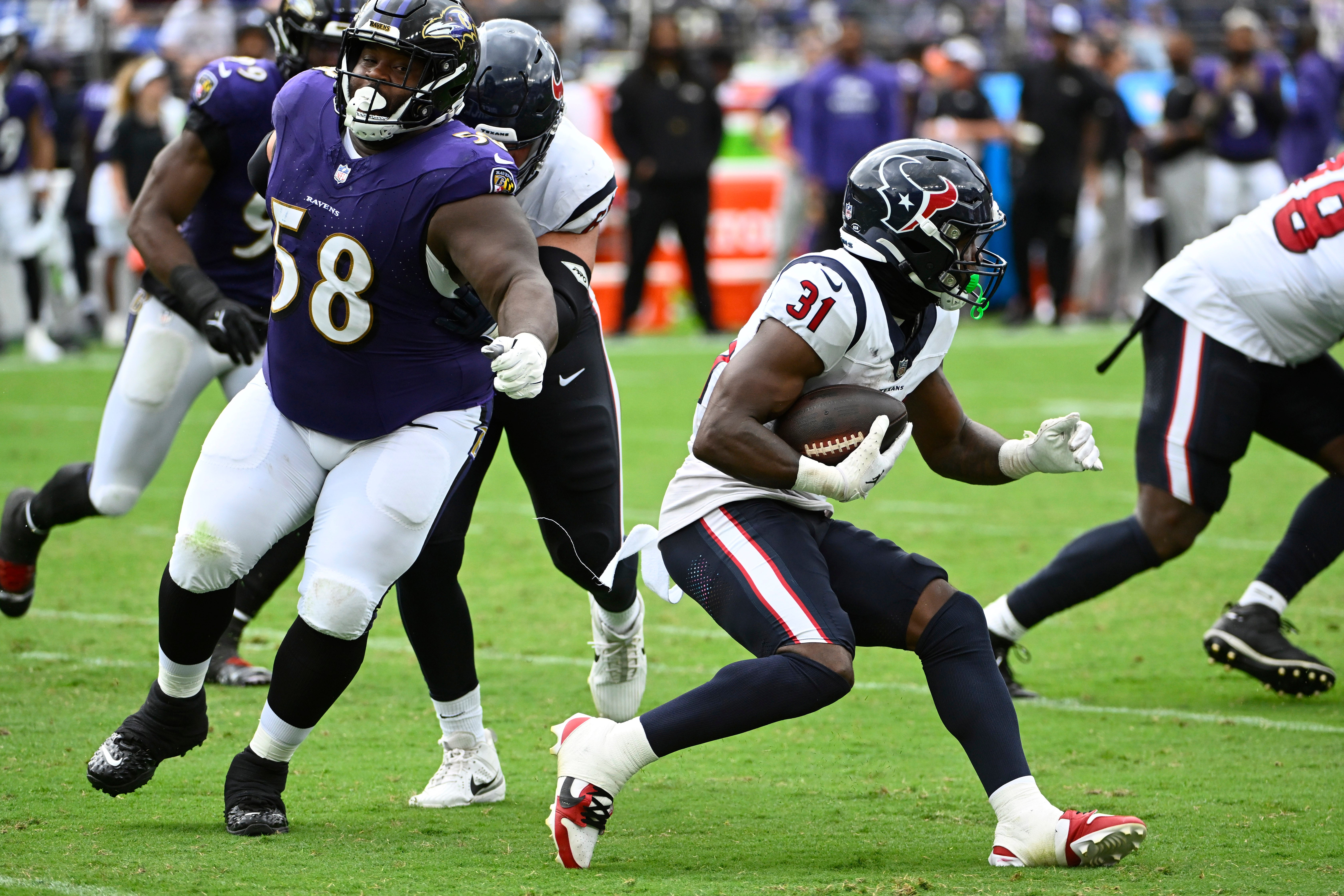 Houston Texans running back Dameon Pierce (31) carries the ball past Baltimore Ravens defensive tackle Michael Pierce (58) during the second half at M&T Bank Stadium.