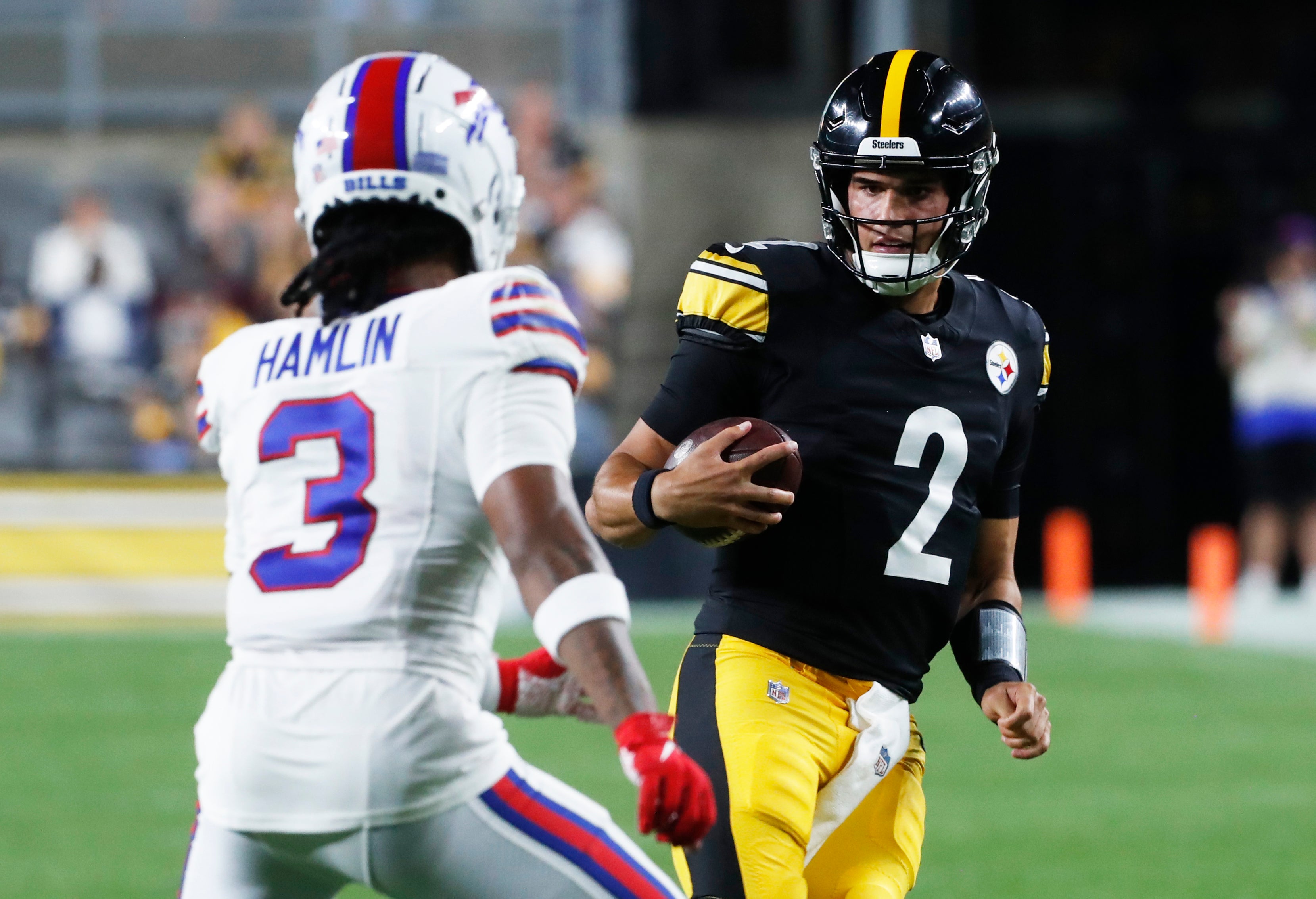 Aug 19, 2023; Pittsburgh, Pennsylvania, USA; Pittsburgh Steelers quarterback Mason Rudolph (2) runs the ball against Buffalo Bills safety Damar Hamlin (3) during the third quarter at Acrisure Stadium. Pittsburgh won 27-15. Mandatory Credit: Charles LeClaire-USA TODAY Sports