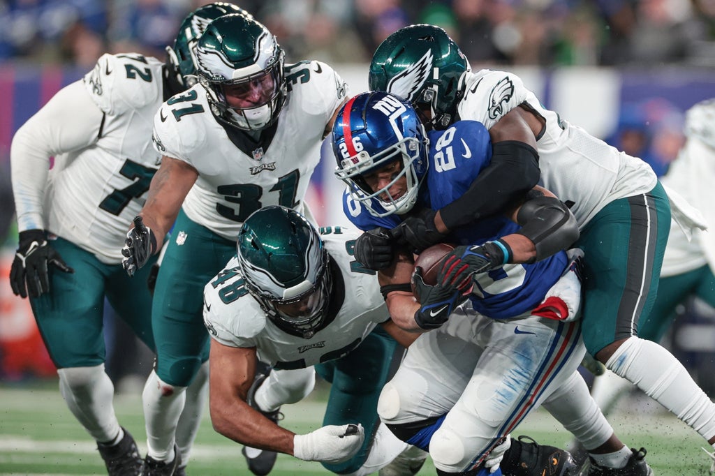 New York Giants running back Saquon Barkley (26) is tackled by Philadelphia Eagles linebacker Nicholas Morrow (41) and linebacker Patrick Johnson (48) and safety Kevin Byard (31) during the second half.