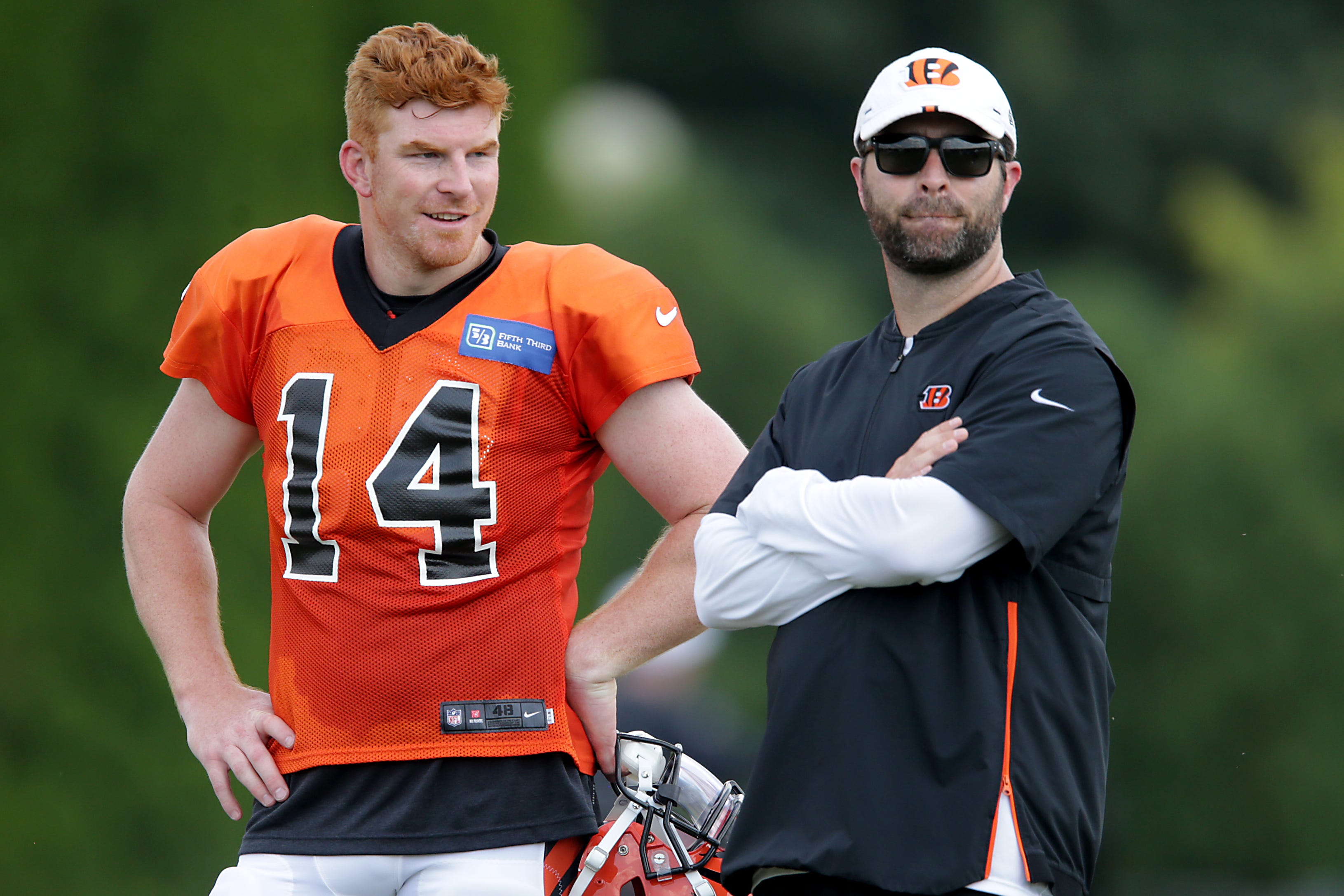 Cincinnati Bengals quarterback Andy Dalton (14), left, talks with Cincinnati Bengals offensive coordinator Brian Callahan during Cincinnati Bengals training camp practice, Wednesday, July 31, 2019, at the practice fields next to Paul Brown Stadium in Cincinnati. Cincinnati Bengals Training Camp July 31