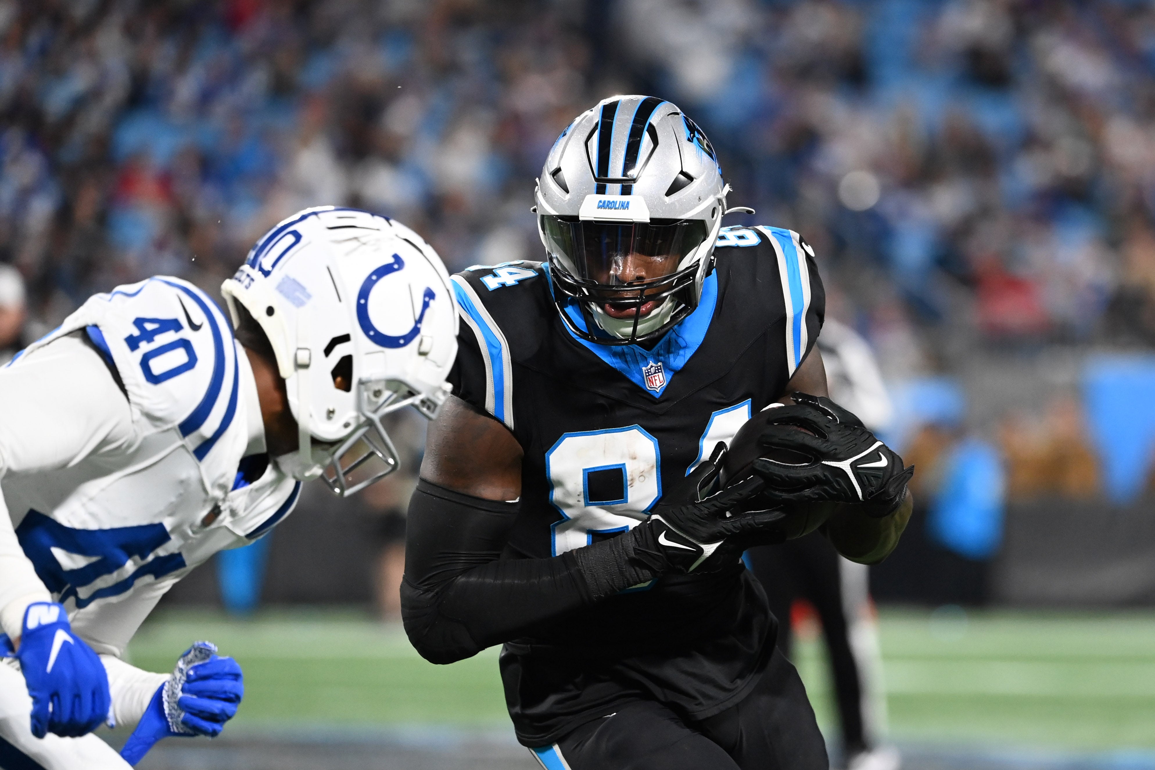 Nov 5, 2023; Charlotte, North Carolina, USA; Carolina Panthers tight end Stephen Sullivan (84) with the ball as Indianapolis Colts cornerback Jaylon Jones (40) defends in the fourth quarter at Bank of America Stadium. Mandatory Credit: Bob Donnan-USA TODAY Sports