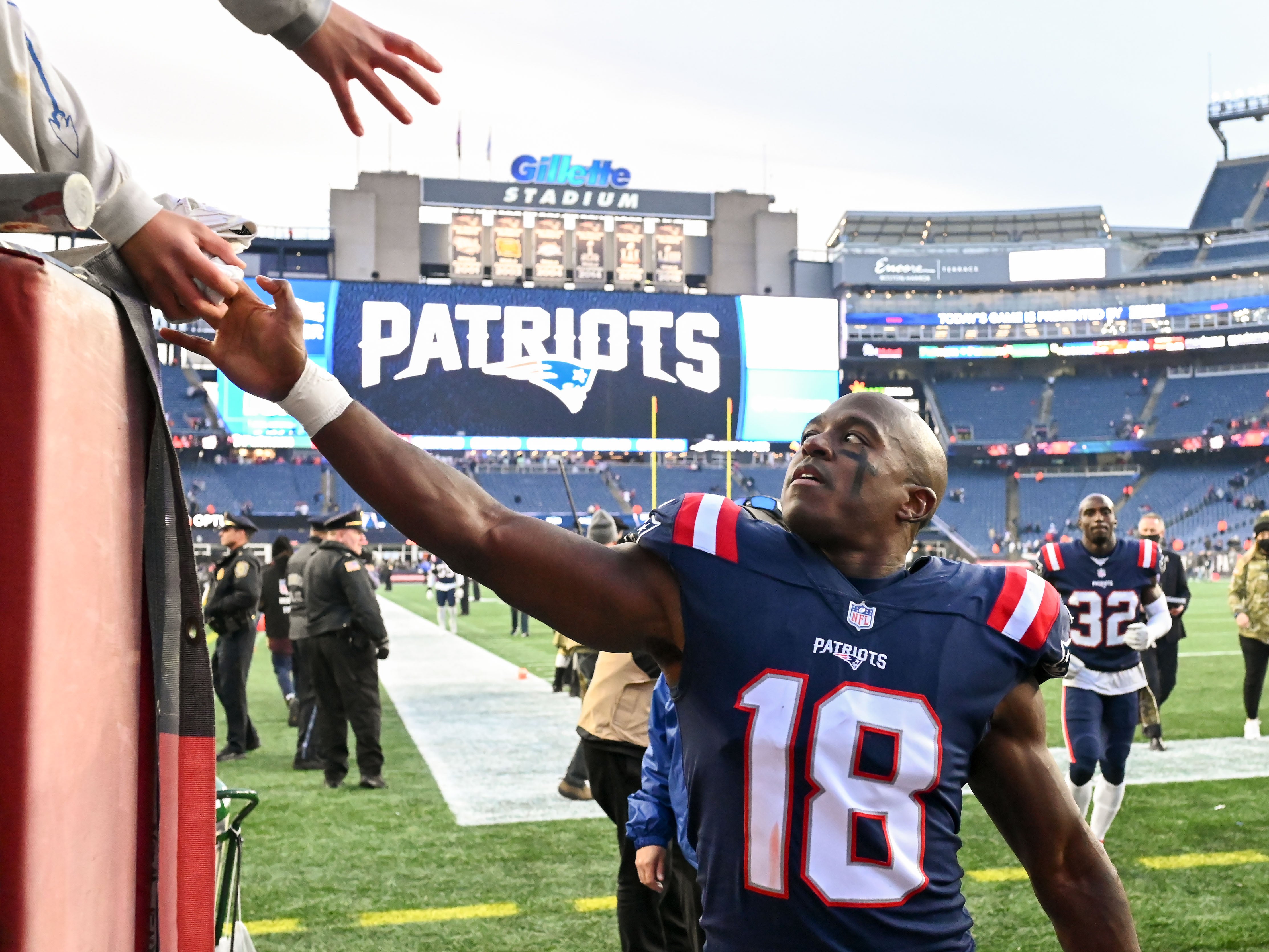 New England Patriots wide receiver Matthew Slater gives a towel to a fan after a game against the Cleveland Browns at Gillette Stadium.