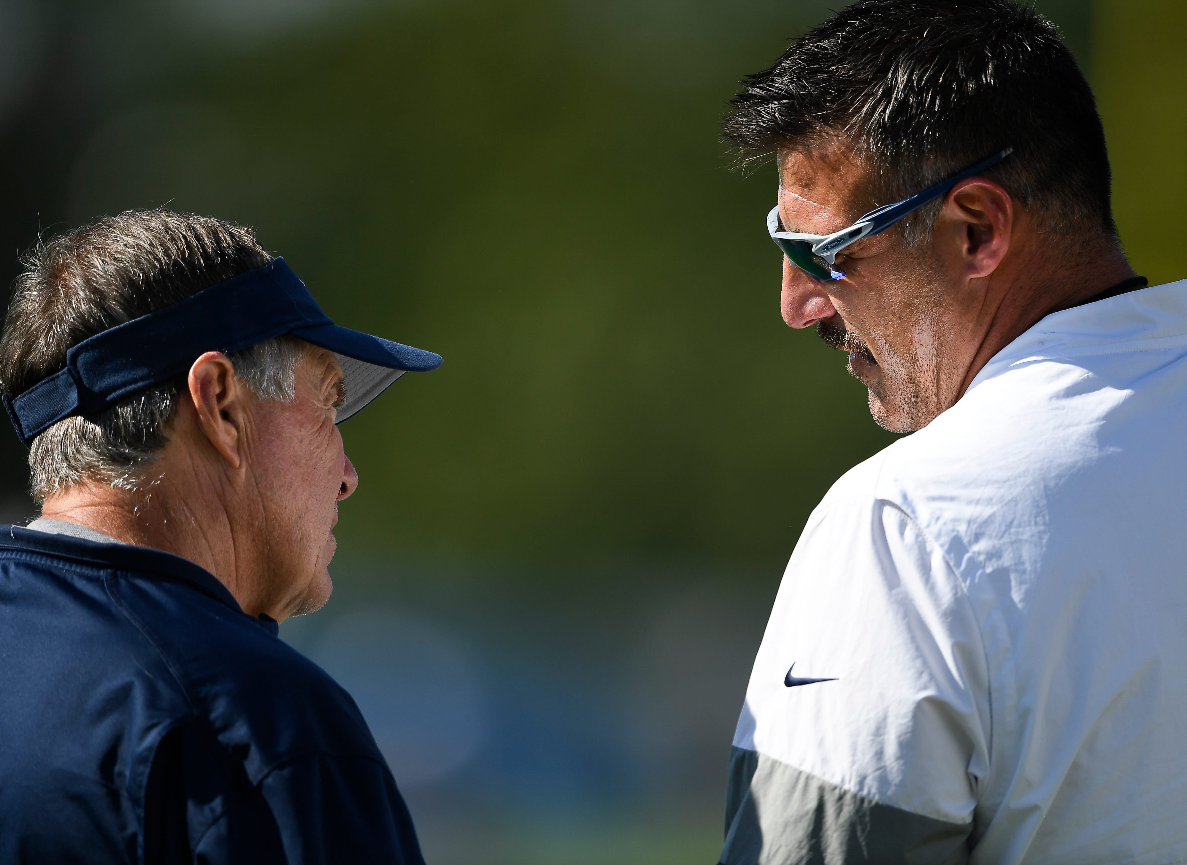 New England Patriots head coach Bill Belichick and Tennessee Titans head coach Mike Vrabel talk with each other before a joint training camp practice at Saint Thomas Sports Park