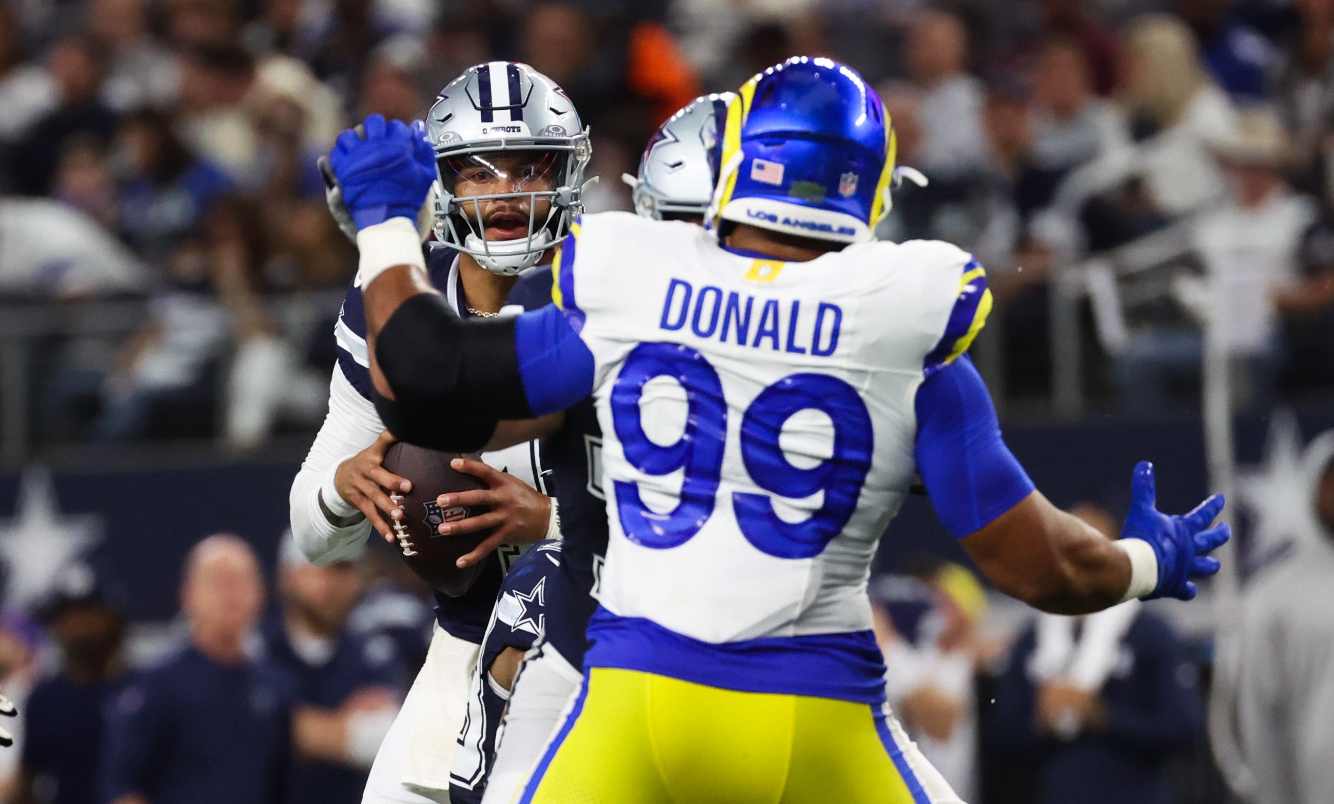 Oct 29, 2023; Arlington, Texas, USA; Dallas Cowboys quarterback Dak Prescott (4) looks to pass as Los Angeles Rams defensive tackle Aaron Donald (99) defends during the game at AT&T Stadium. Mandatory Credit: Kevin Jairaj-USA TODAY Sports