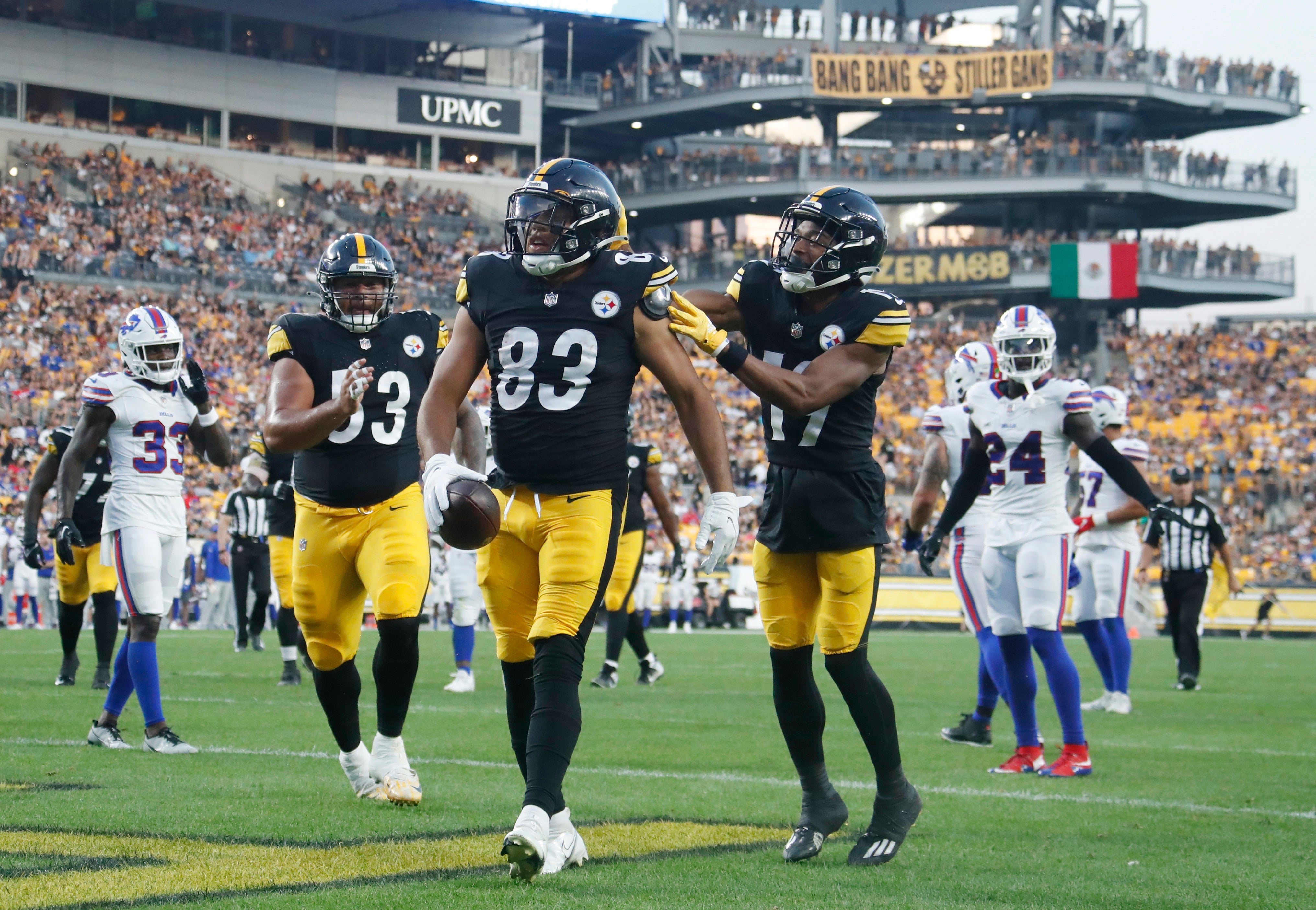 Aug 19, 2023; Pittsburgh, Pennsylvania, USA; Pittsburgh Steelers center Kendrick Green (53) and wide receiver Calvin Austin III (19) celebrate a touchdown by tight end Connor Heyward (83) against the Buffalo Bills during the second quarter at Acrisure Stadium. Mandatory Credit: Charles LeClaire-USA TODAY Sports