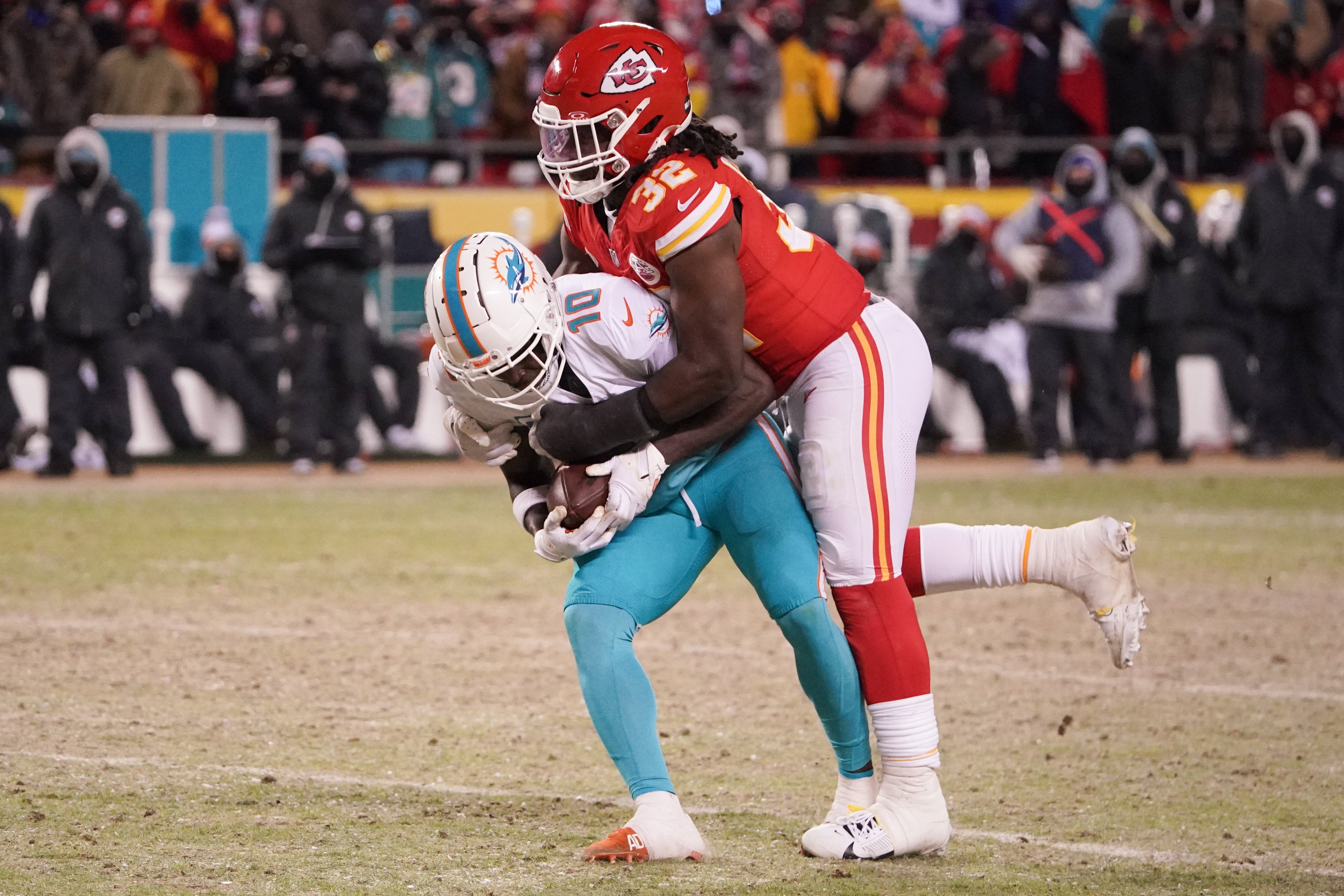 Miami Dolphins wide receiver Tyreek Hill is brought down by Kansas City Chiefs linebacker Nick Bolton during the second half of the 2024 AFC wild card game at GEHA Field at Arrowhead Stadium.