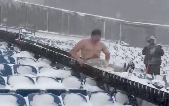 Shirtless Bills fan helping shovel at Highmark Stadium