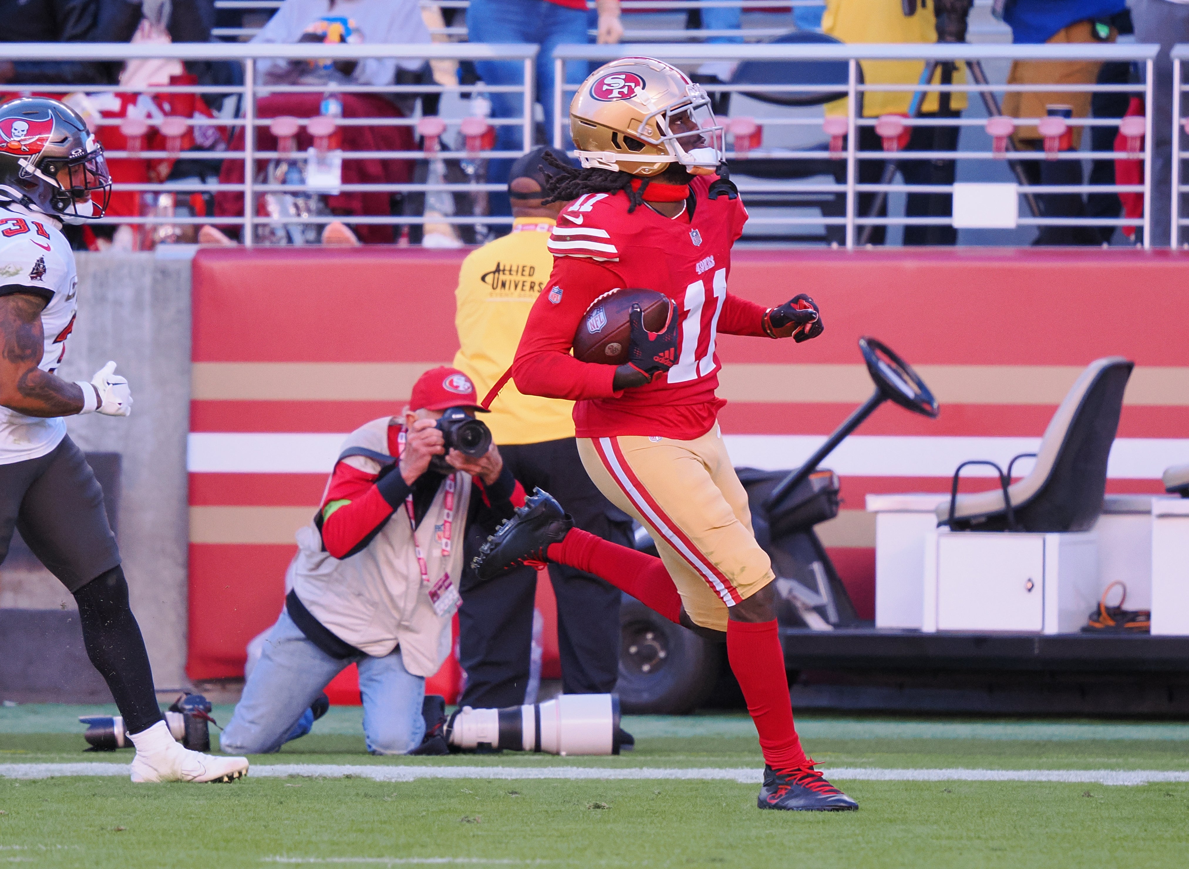 Nov 19, 2023; Santa Clara, California, USA; San Francisco 49ers wide receiver Brandon Aiyuk (11) runs after a catch for a 76-yard touchdown against the Tampa Bay Buccaneers during the third quarter at Levi's Stadium.