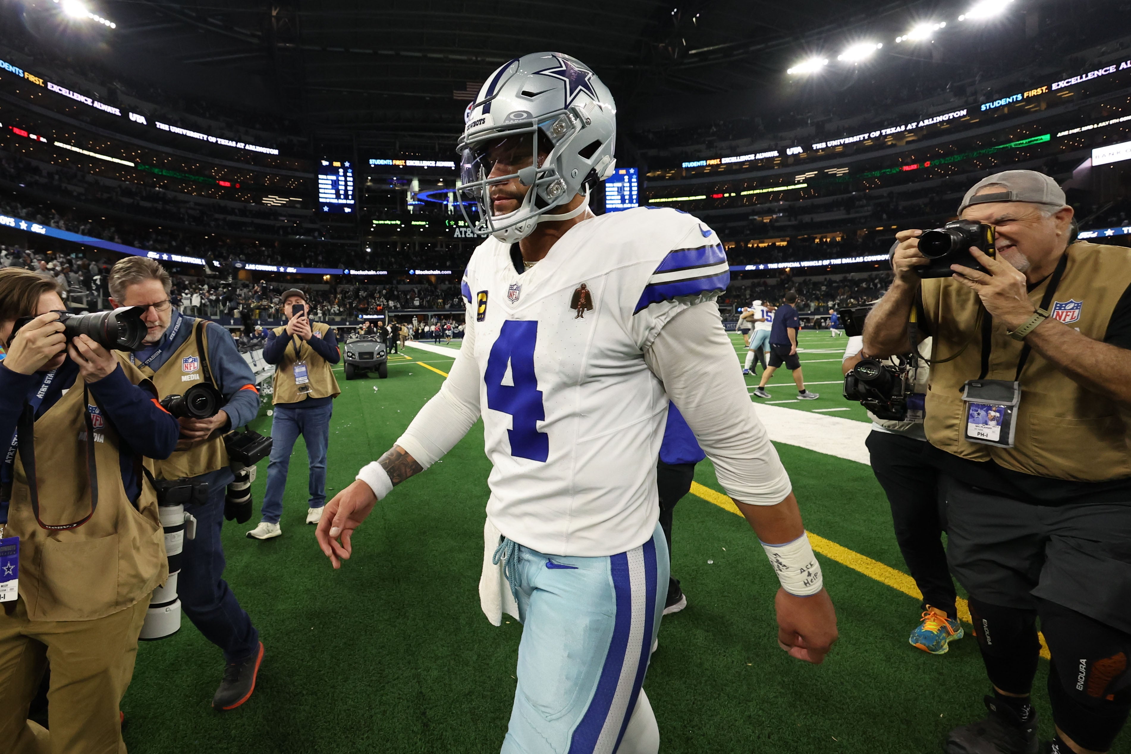 Jan 14, 2024; Arlington, Texas, USA; Dallas Cowboys quarterback Dak Prescott (4) walks off the field against the Green Bay Packers after the 2024 NFC wild card game at AT&T Stadium.