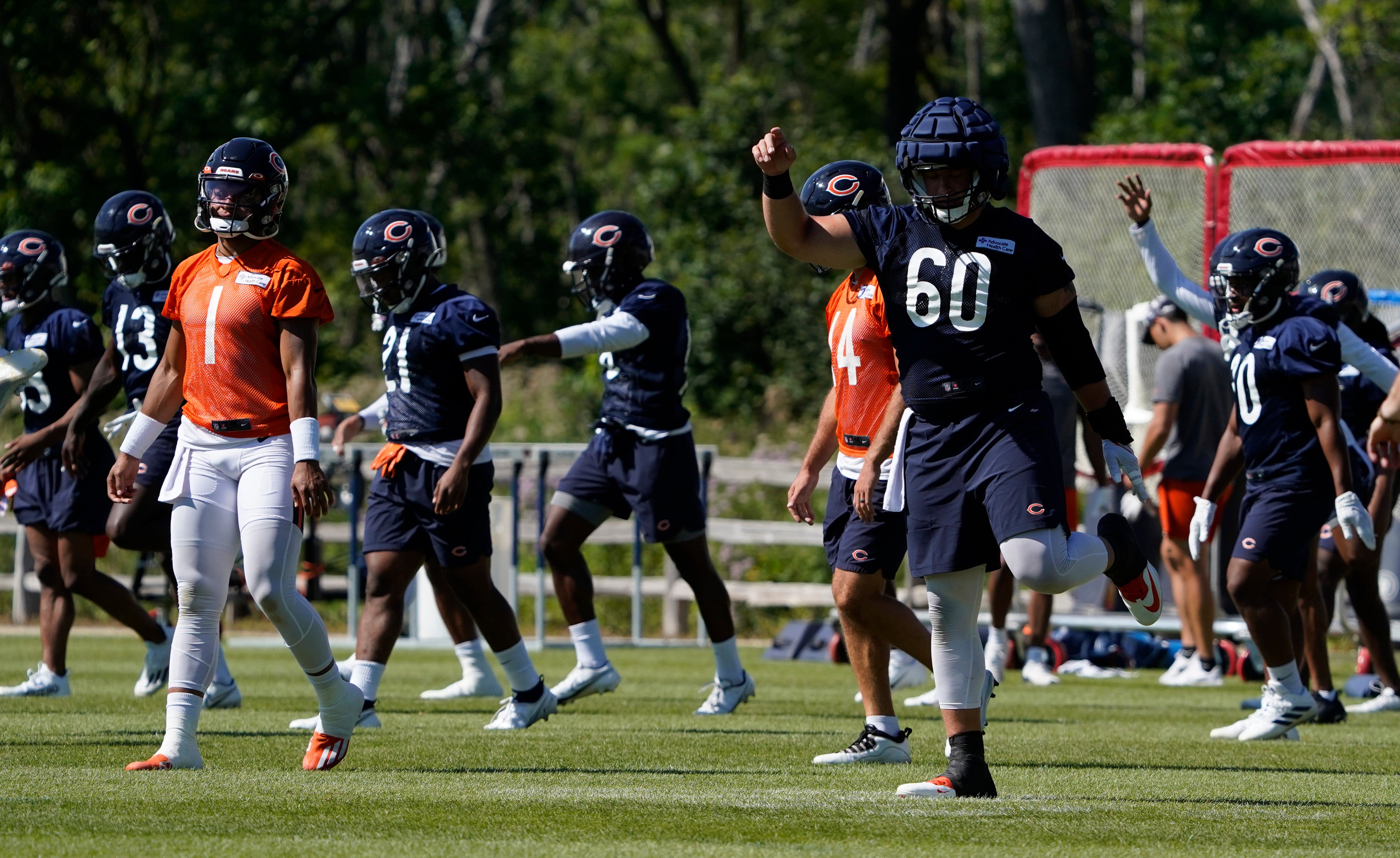 Jul 30, 2022; Lake Forest Illinois, US; Chicago Bears players stretch during training camp at Halas Hall.