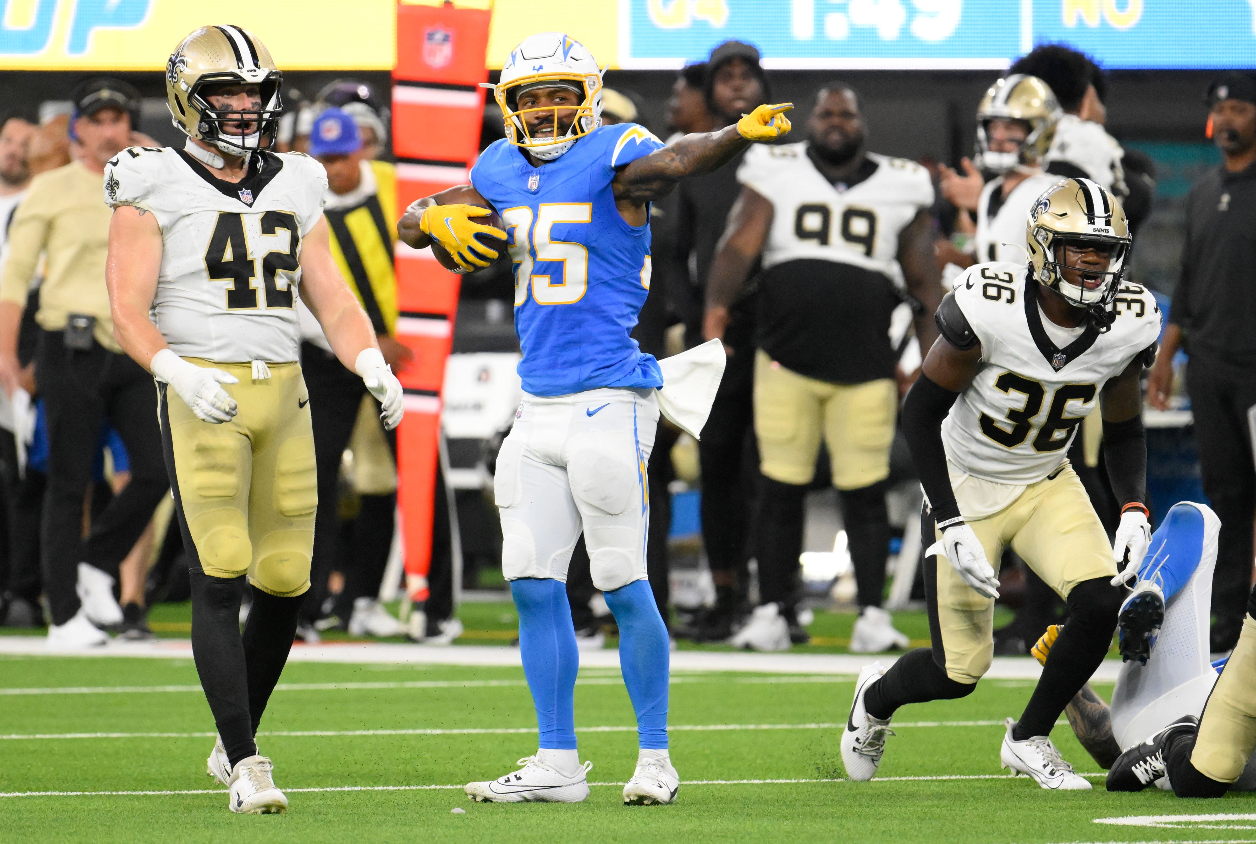 Aug 20, 2023; Inglewood, California, USA; Los Angeles Chargers wide receiver Terrell Bynum (35) signals a first down after making a catch in the fourth quarter against the New Orleans Saints at SoFi Stadium. Left is New Orleans Saints linebacker Ty Summers (42), right is New Orleans Saints cornerback Anthony Johnson (36).
