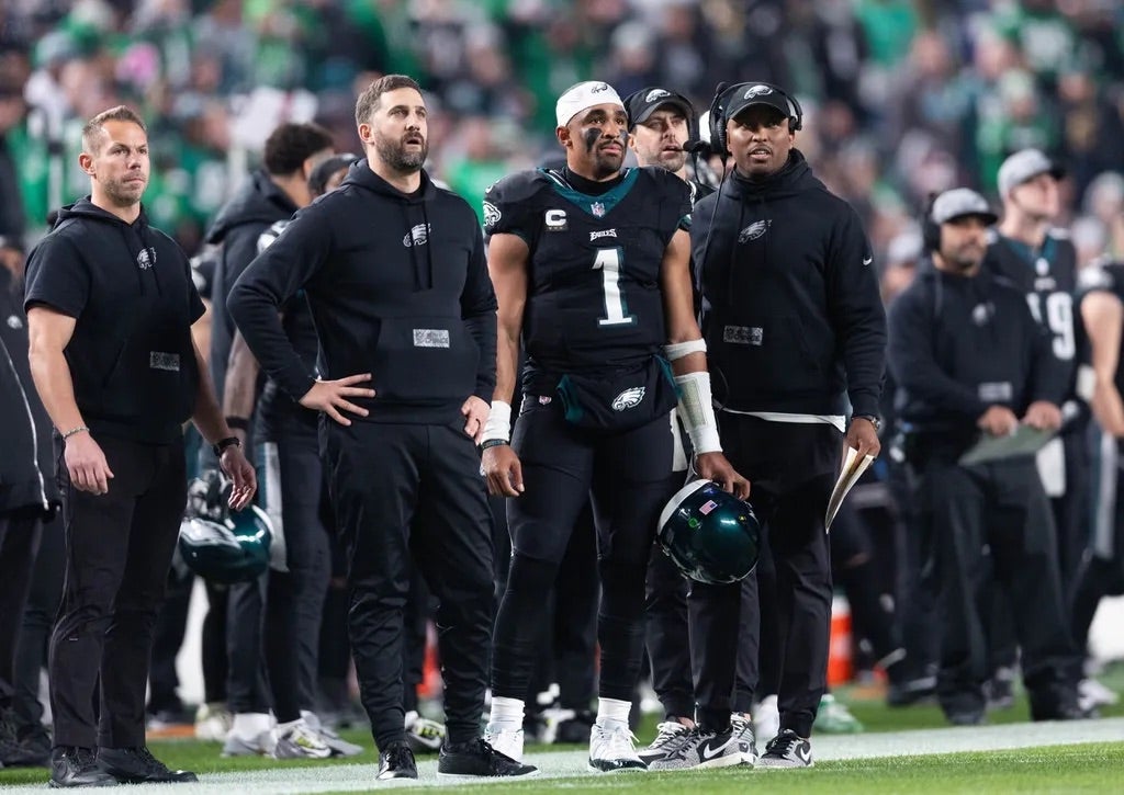 Philadelphia Eagles head coach Nick Sirianni (L) and quarterback Jalen Hurts (1) and offensive coordinator Brian Johnson (R) look on during the second quarter against the New York Giants at Lincoln Field.