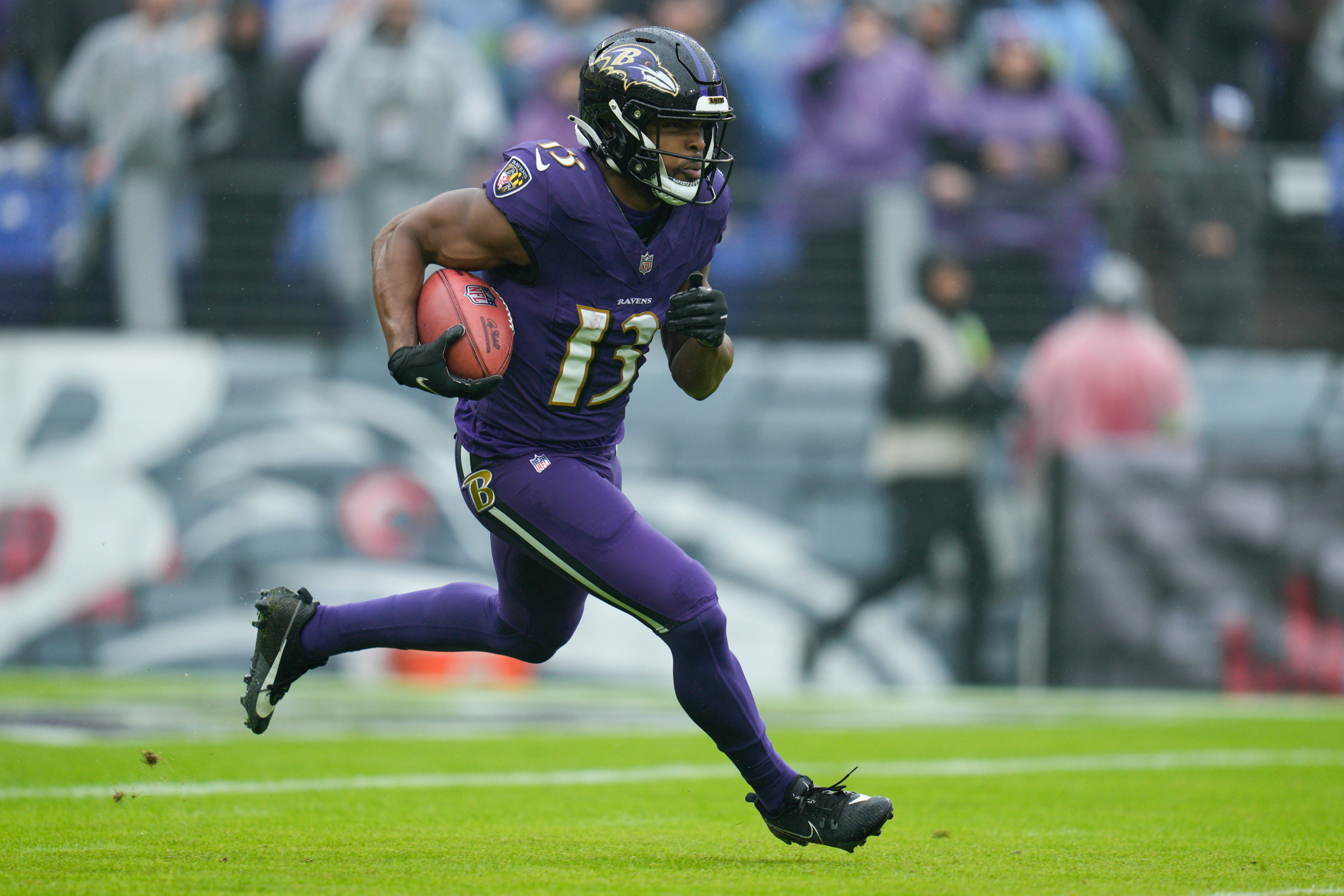 Baltimore Ravens wide receiver Devin Duvernay (13) runs with the ball during the first quarter against the Los Angeles Rams at M&T Bank Stadium.