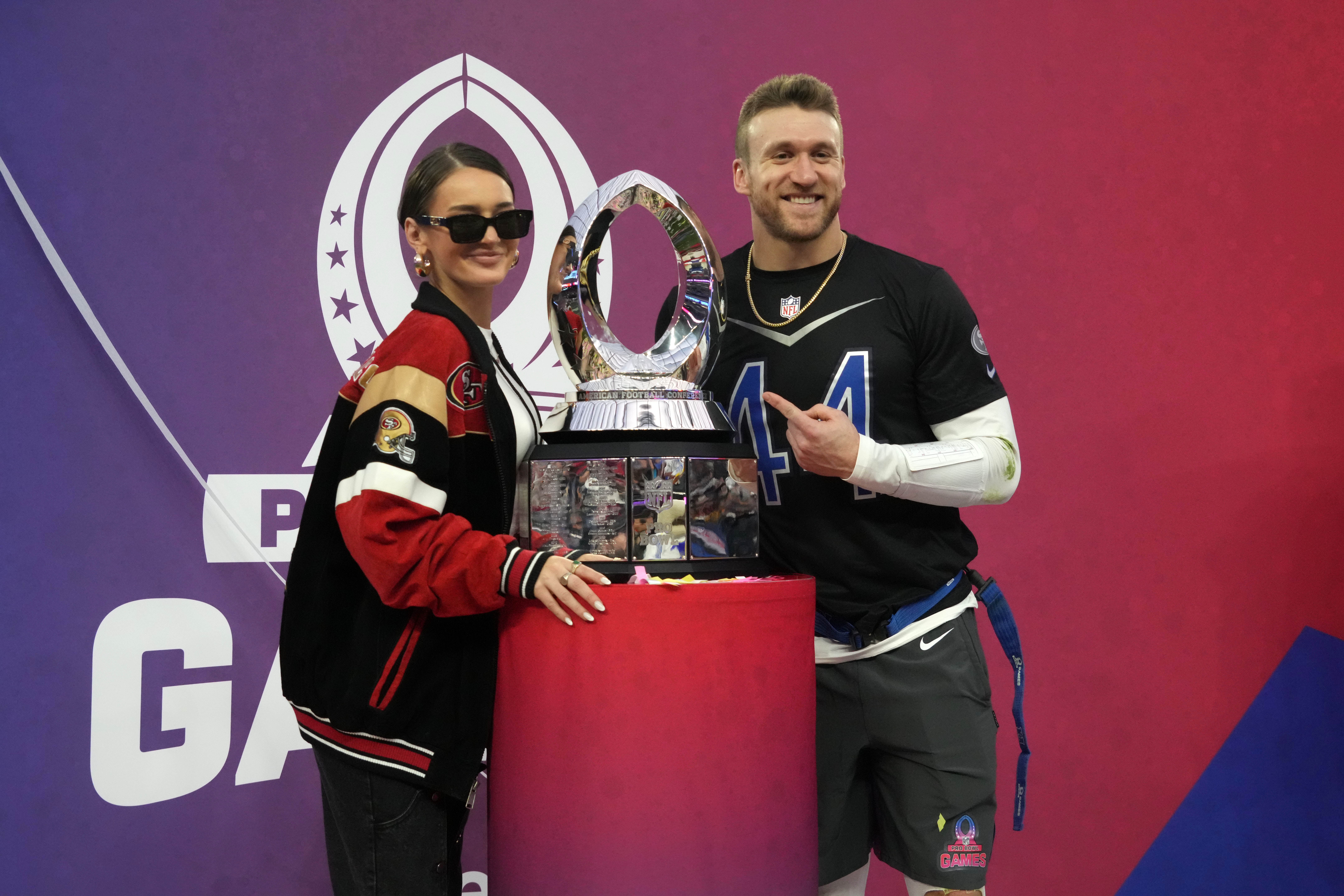 Feb 5, 2023; Paradise, Nevada, USA; NFC fullback Kyle Juszczyk of the San Francisco 49ers (44) and wife Kristin Juszcyk pose with trophy during the Pro Bowl Games at Allegiant Stadium.